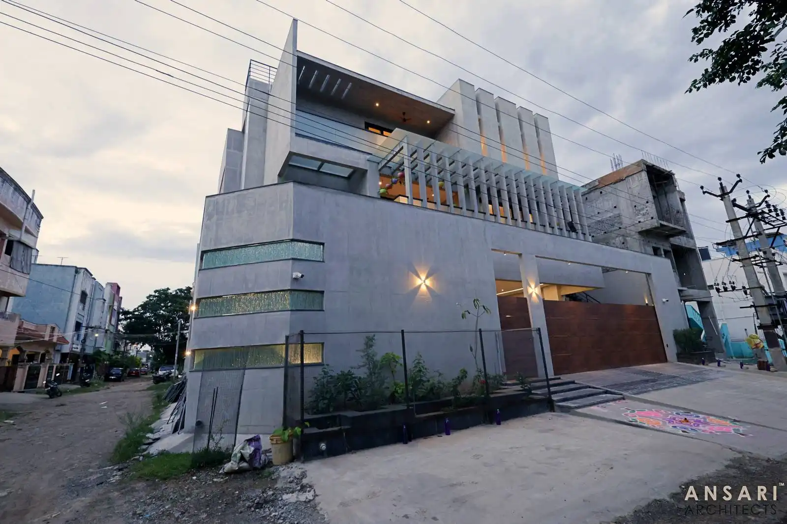 Designed with bold volumes and perforated screens, this residence balances light, privacy, and form through minimalist openings and layered textures for striking visual depth.