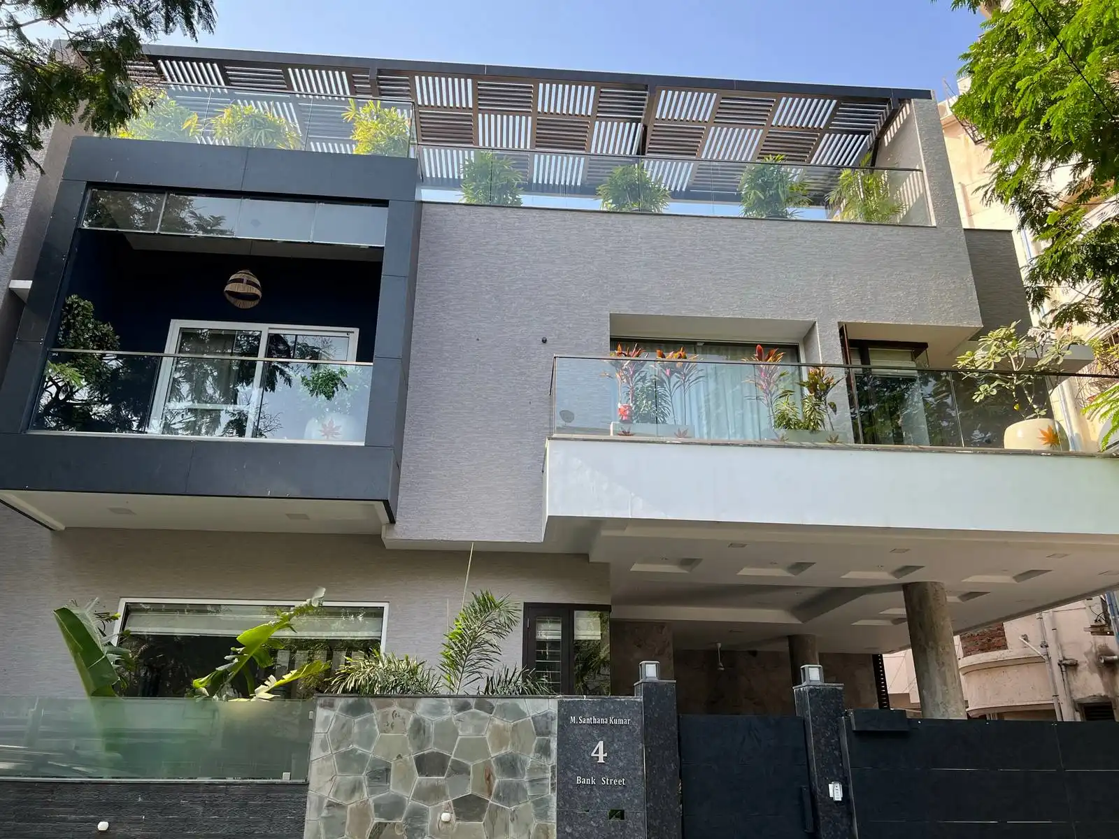 Large glass railings on the balconies and terrace create a sense of openness and allow for unobstructed views.
