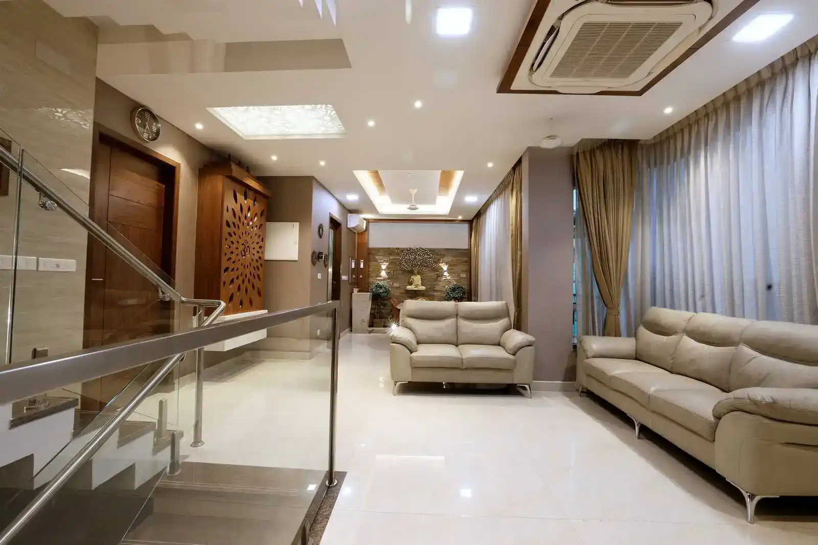 First floor living area is open and spacious, with a clear circulation path from the staircase to the seating zone. Large floor-to-ceiling windows with sheer curtains allow natural light to flood the room.