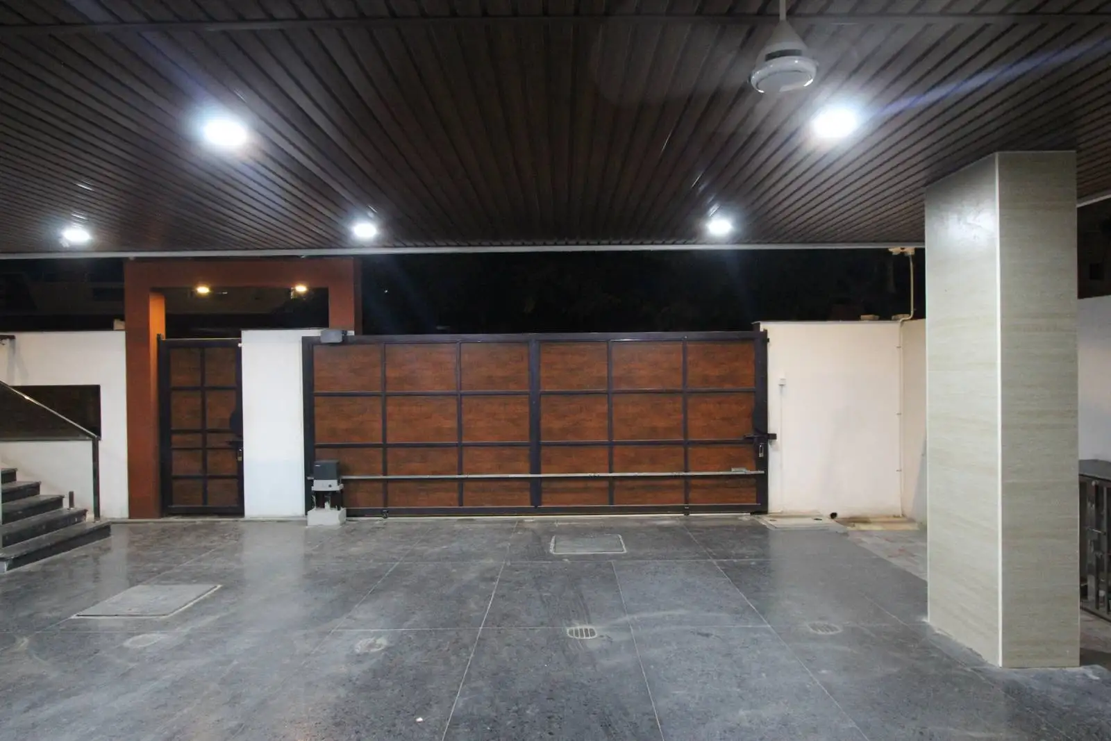 The area is a spacious, covered driveway, providing shelter for vehicles and a welcoming entrance to the property.