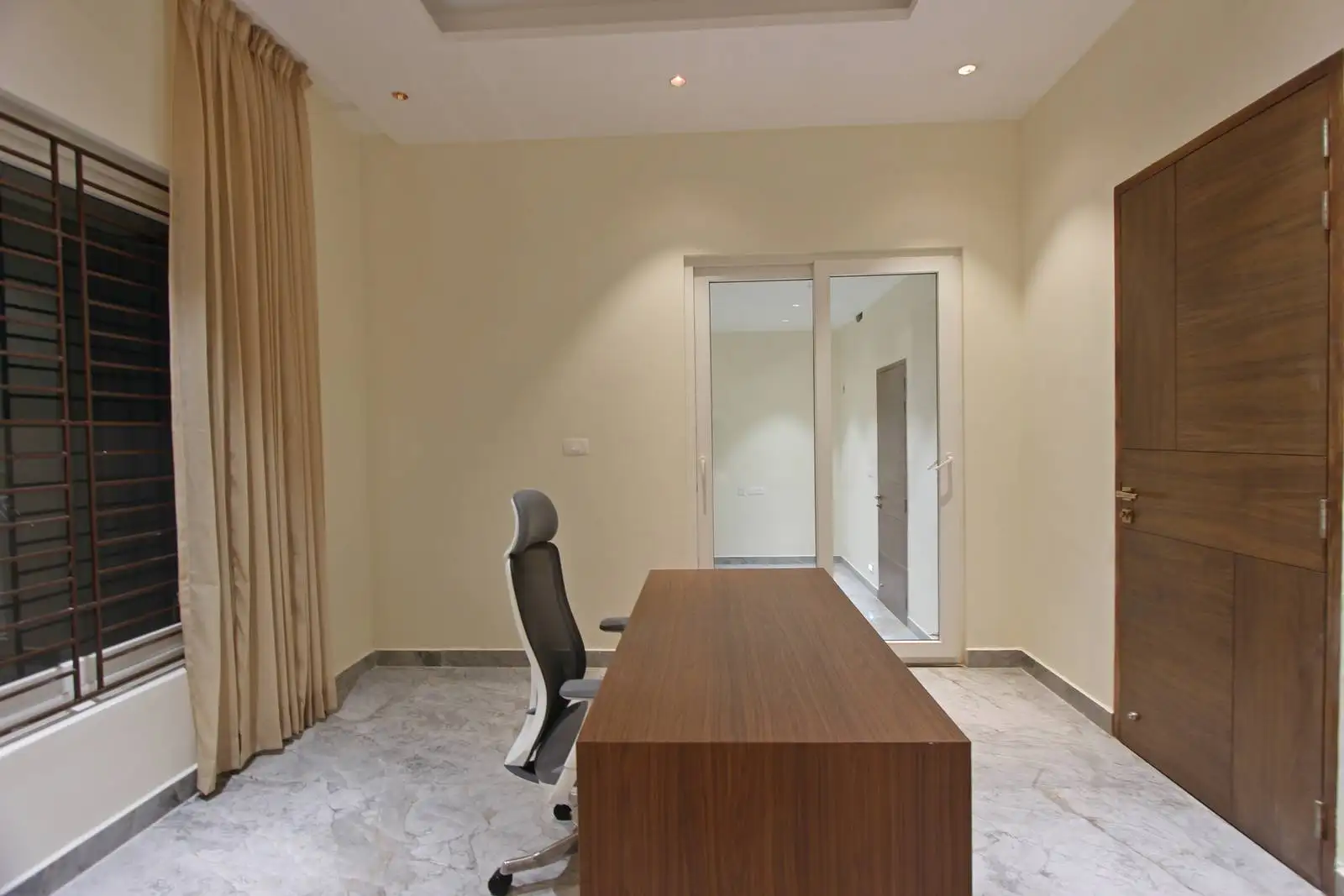 Expansive glass sliding doors fill the room with natural light and connect seamlessly to adjoining areas.