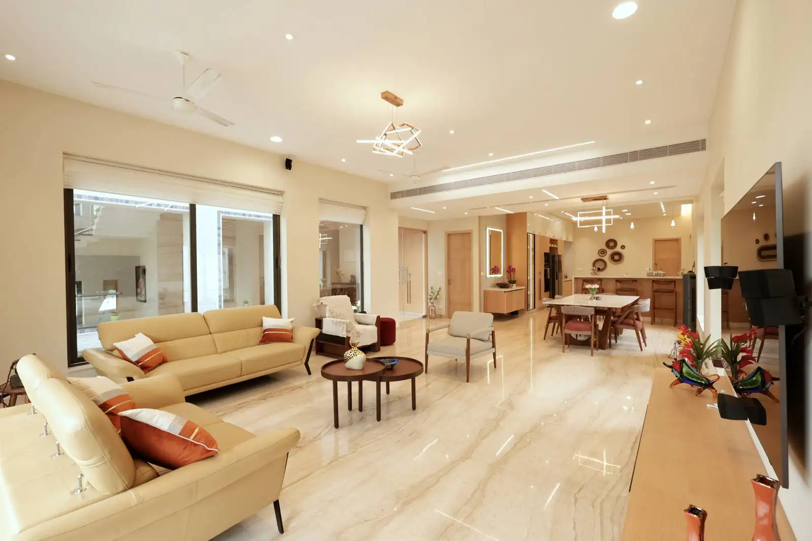 Large windows along one wall allow abundant natural light, visually connecting the interior to the outdoors and enhancing the airy feel.