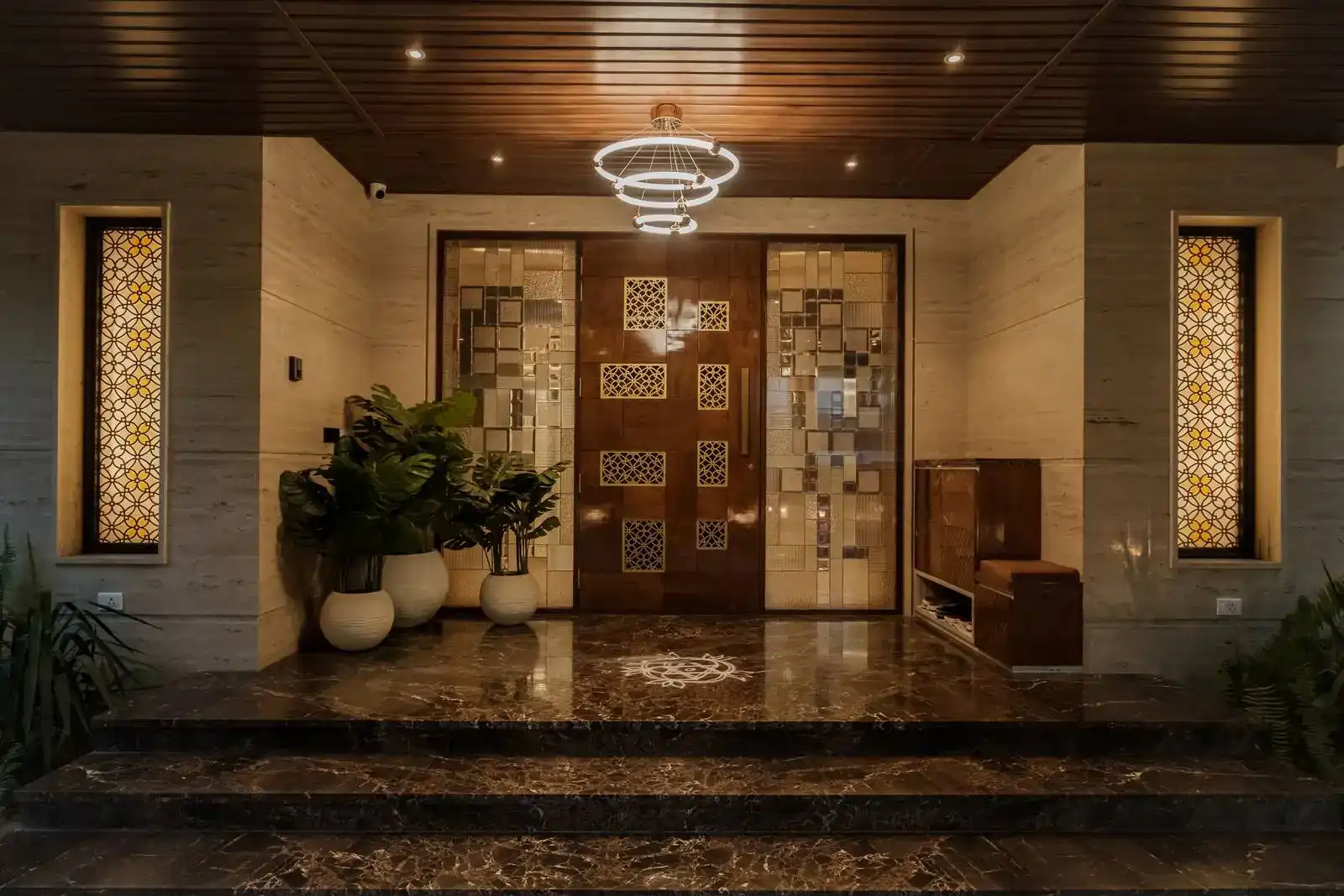 Grand verandah with polished marble steps and a symmetrical layout, creating an elegant transition from the outdoors to the entrance.