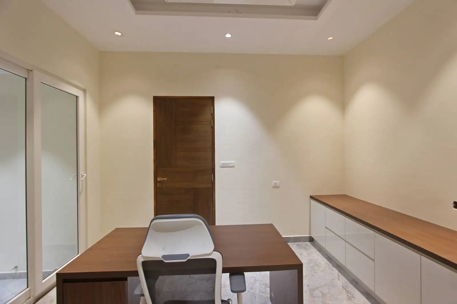 Built-in white cabinets with a wooden countertop offer seamless storage and workspace.