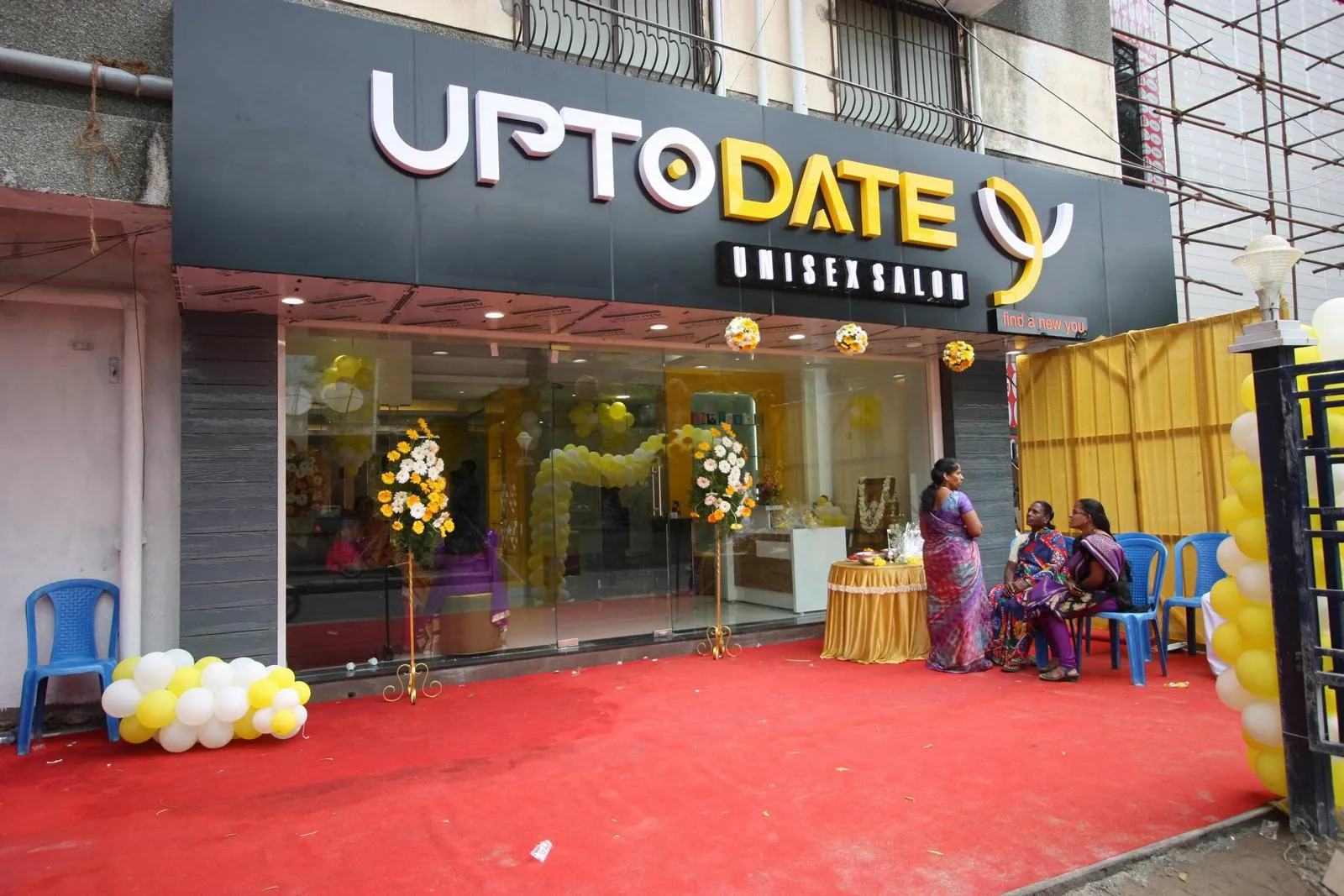 The commercial facade features clean lines, bold signage, and clear glazing for a modern, welcoming look. Black finishes, gold accents, and textured cladding strengthen brand presence while drawing light and views into the interior.