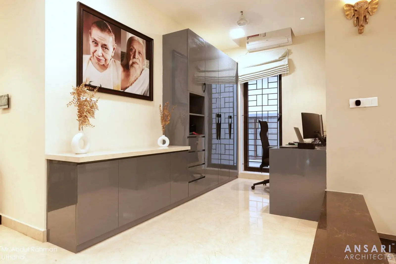 The study room is long and rectangular, efficiently utilizing the available space with built-in cabinetry along one wall and a dedicated workspace at the far end.