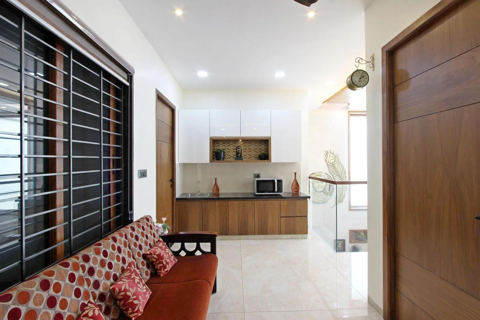 The second-floor family room is a compact, multi-functional space with integrated seating and a small pantry, ideal for informal gatherings. A large window ensures ample natural light, cross-ventilation, and a comfortable, well-balanced environment.