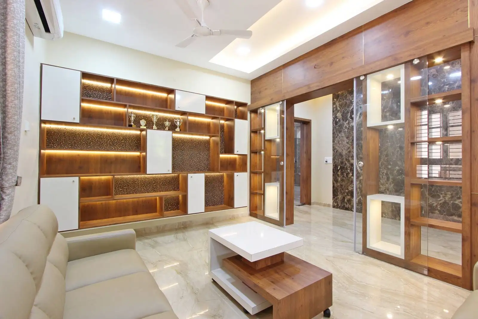 Striking feature wall with illuminated shelves and integrated storage, blending display and function for a clean, sophisticated look.