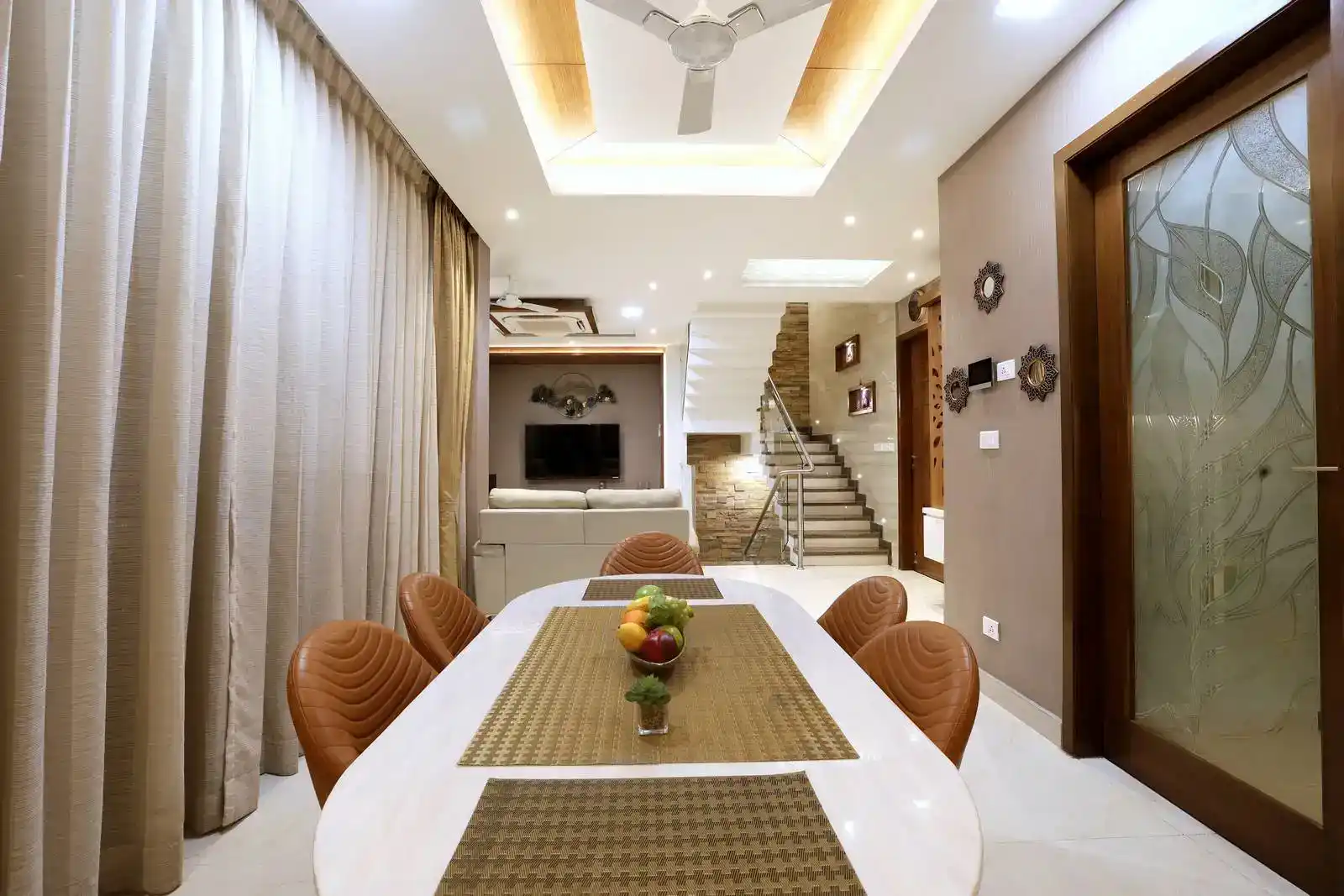 Space features an open-plan layout, seamlessly connecting the dining area, living room, and staircase.