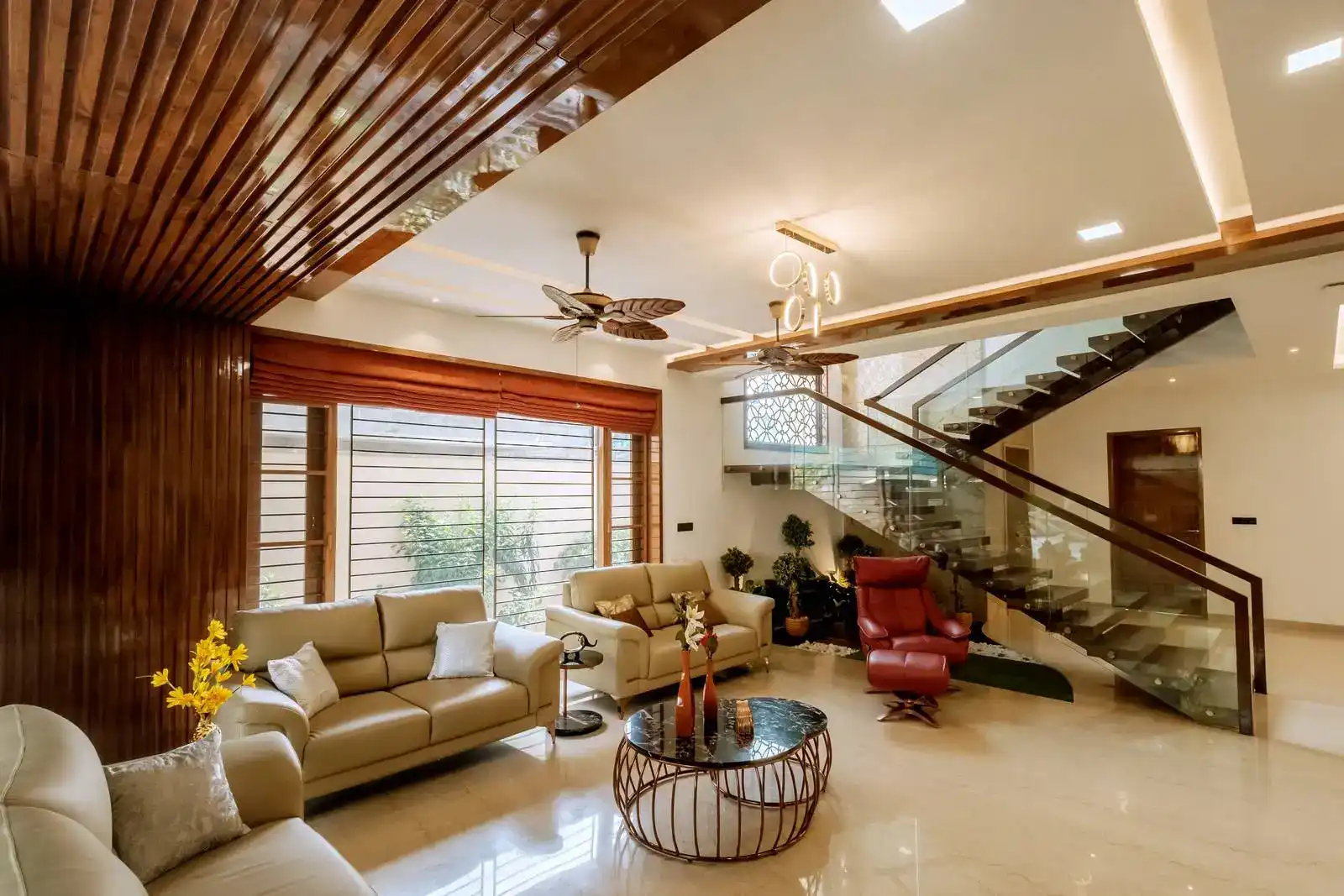 Spacious living room with open layout, abundant natural light, and seamless connection to staircase and adjacent areas.