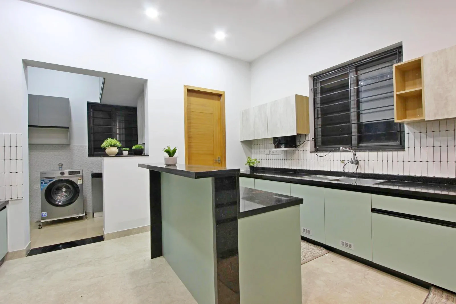 The kitchen features a linear counter and island for efficient cooking and casual dining, with a wet kitchen and hidden store for functional workflow. 