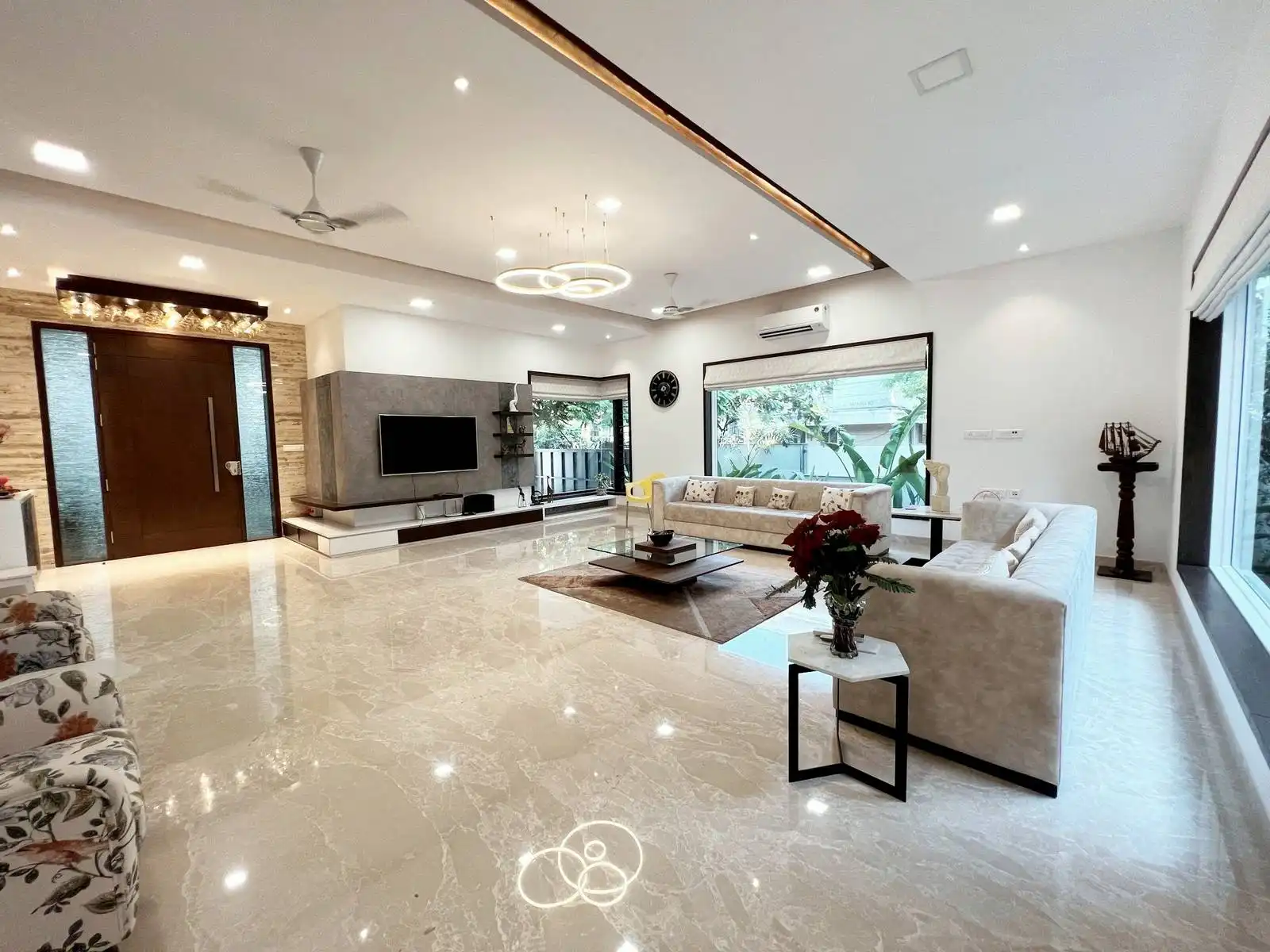 Open-plan layout for fluid movement and visual connectivity between living, dining. Large windows for daylighting and outdoor views.