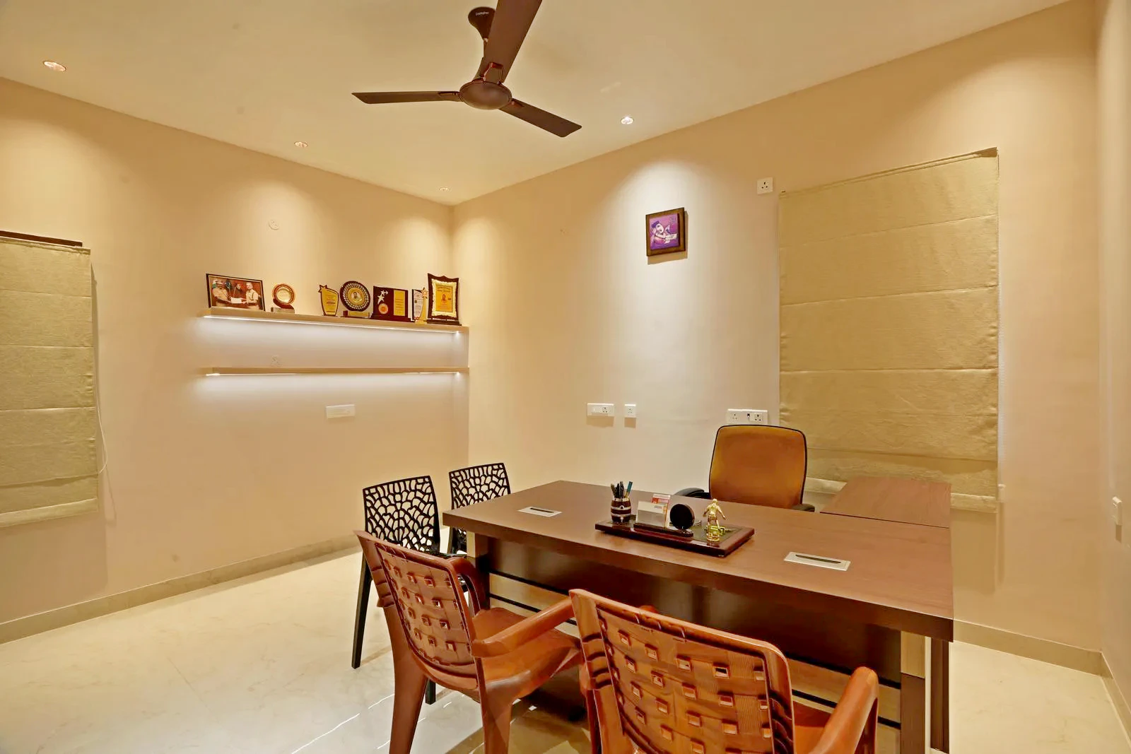 Office Design ( 12'0" x 14'0" sq.ft ) combines a central desk layout with visitor seating, balanced natural light, and open circulation. Warm wooden furniture, polished marble flooring, and subtle beige walls create a functional, sophisticated, and focused workspace.