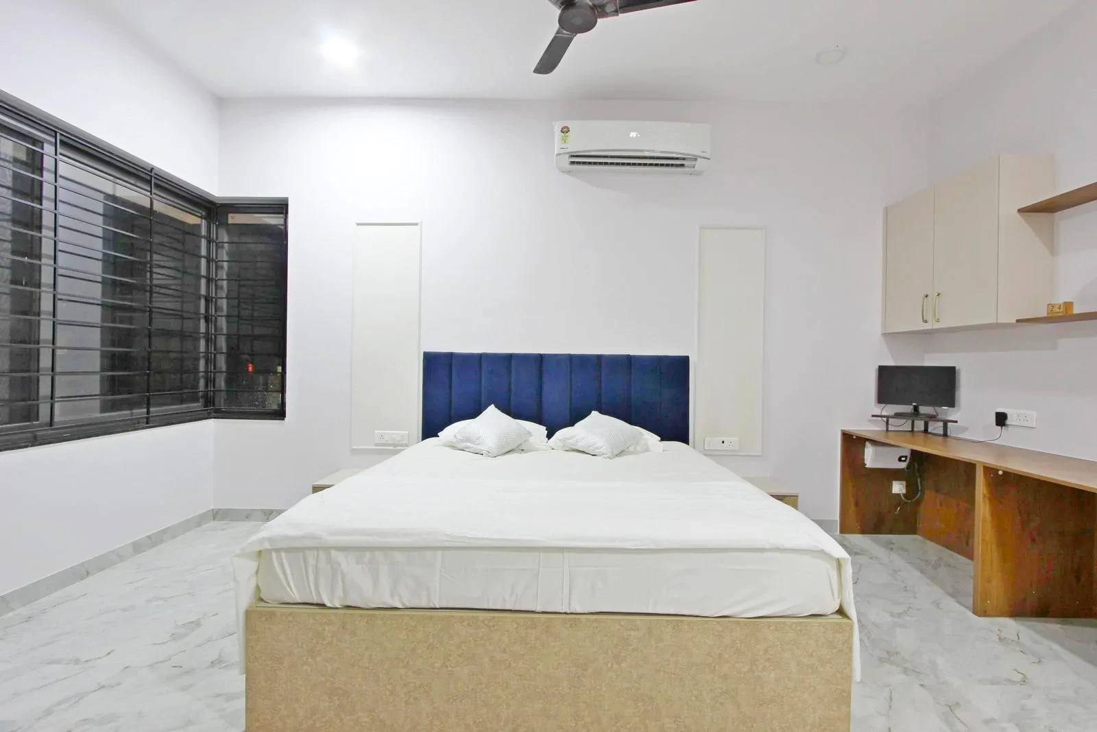 The study table is positioned along the wall, creating a compact, functional workspace within the bedroom while maintaining open circulation and visual balance.