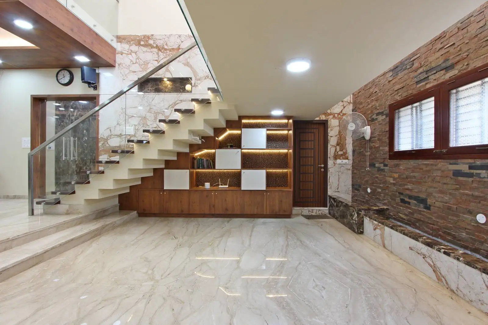 A custom-designed under-stair unit transforms transitional space into functional storage and curated display.