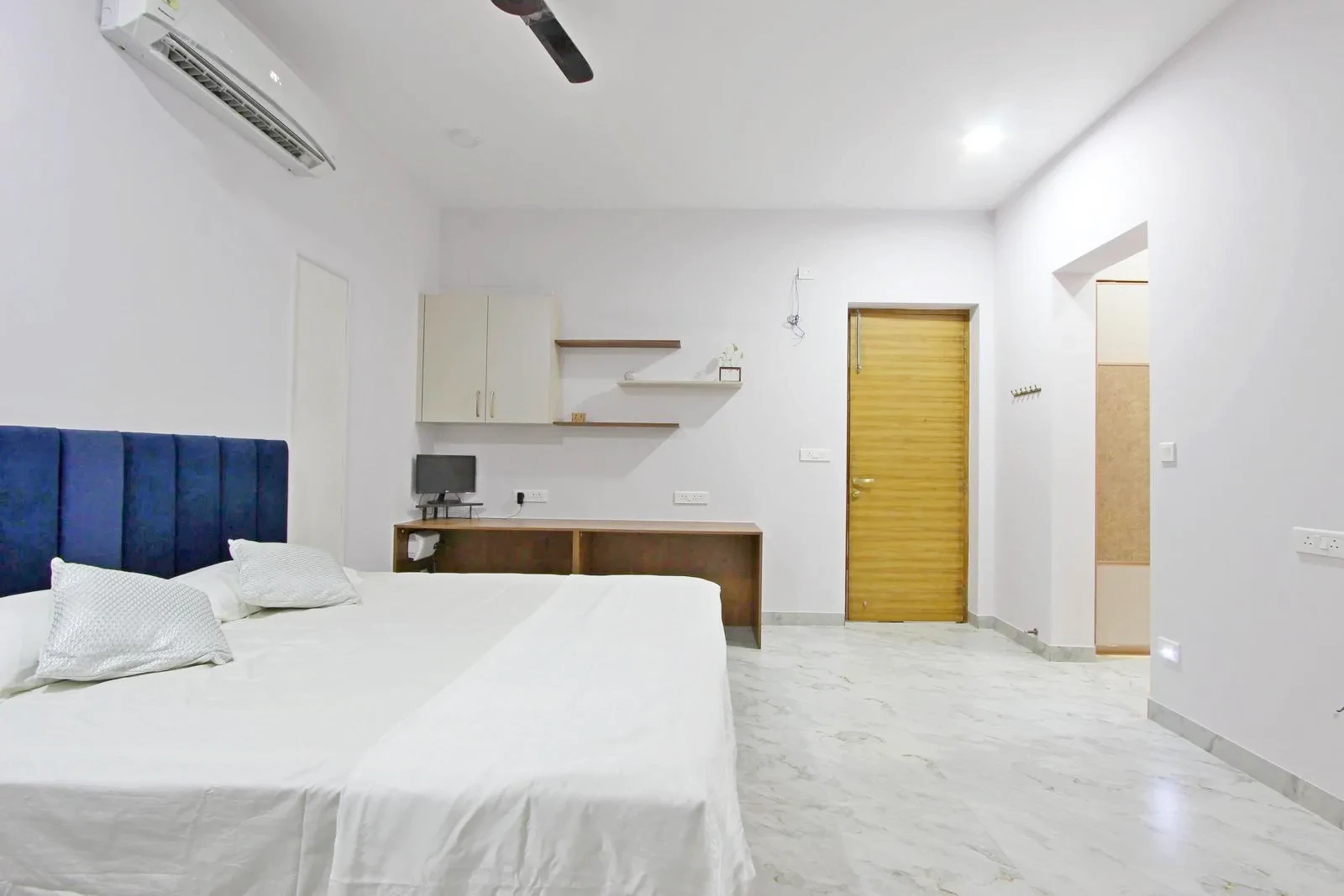 The dressing room is accessed via an open passage, offering privacy and convenient connectivity. Thoughtful door placement ensures smooth circulation between sleeping, working, and dressing areas.