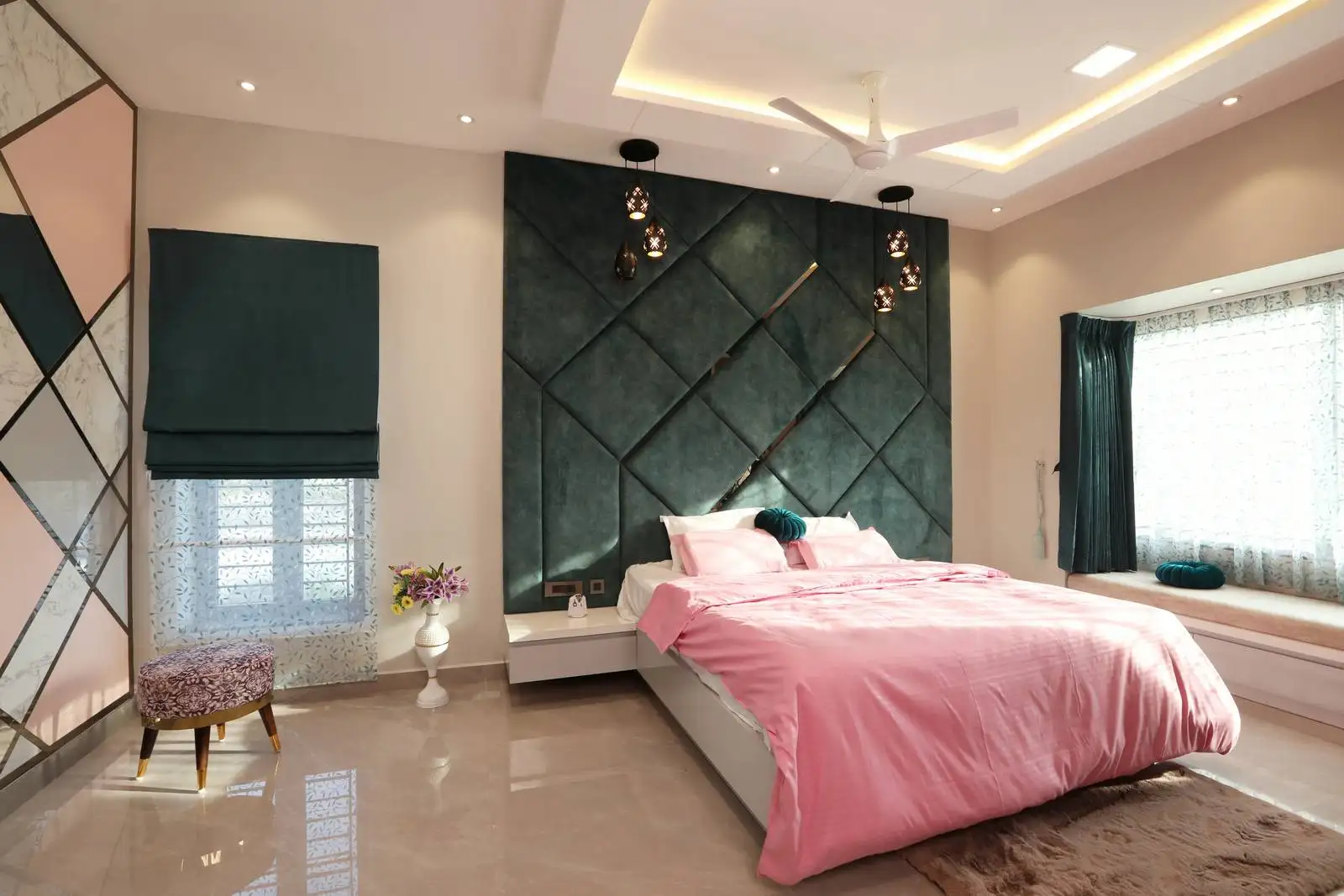 A large window with teal Roman blinds and sheer curtains maximizes natural light, adds style, and ensures privacy with soft, diffused glow.