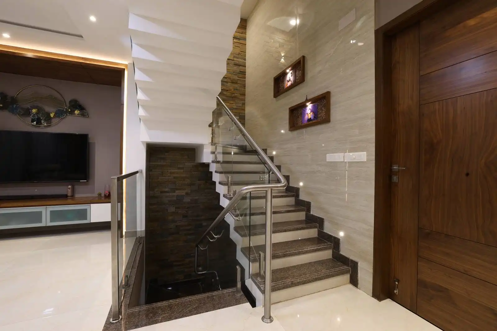Staircase is centrally located, connecting the ground floor to the first floor with a straight flight and a landing. The design maximizes the use of vertical space and integrates seamlessly with the adjacent living area.