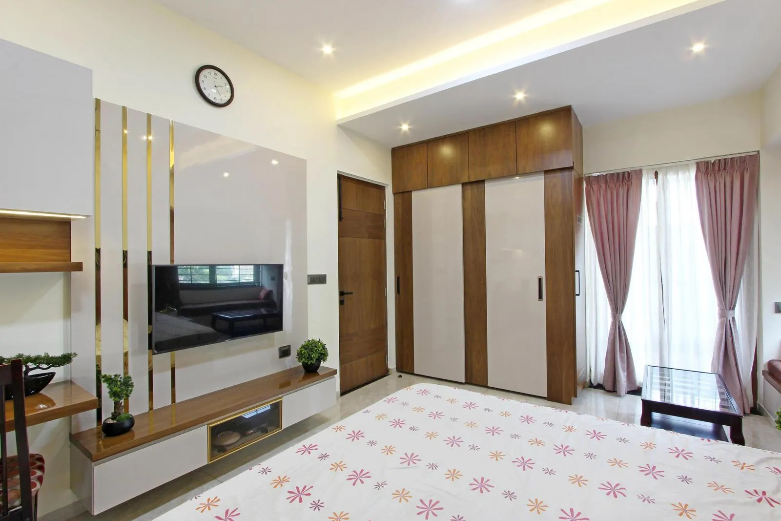 A cozy window seat, warm walnut tones, muted rose curtains, and layered lighting create a bright, functional, and inviting space. Integrated furniture and window seating enhance circulation, visual balance, and spatial depth.