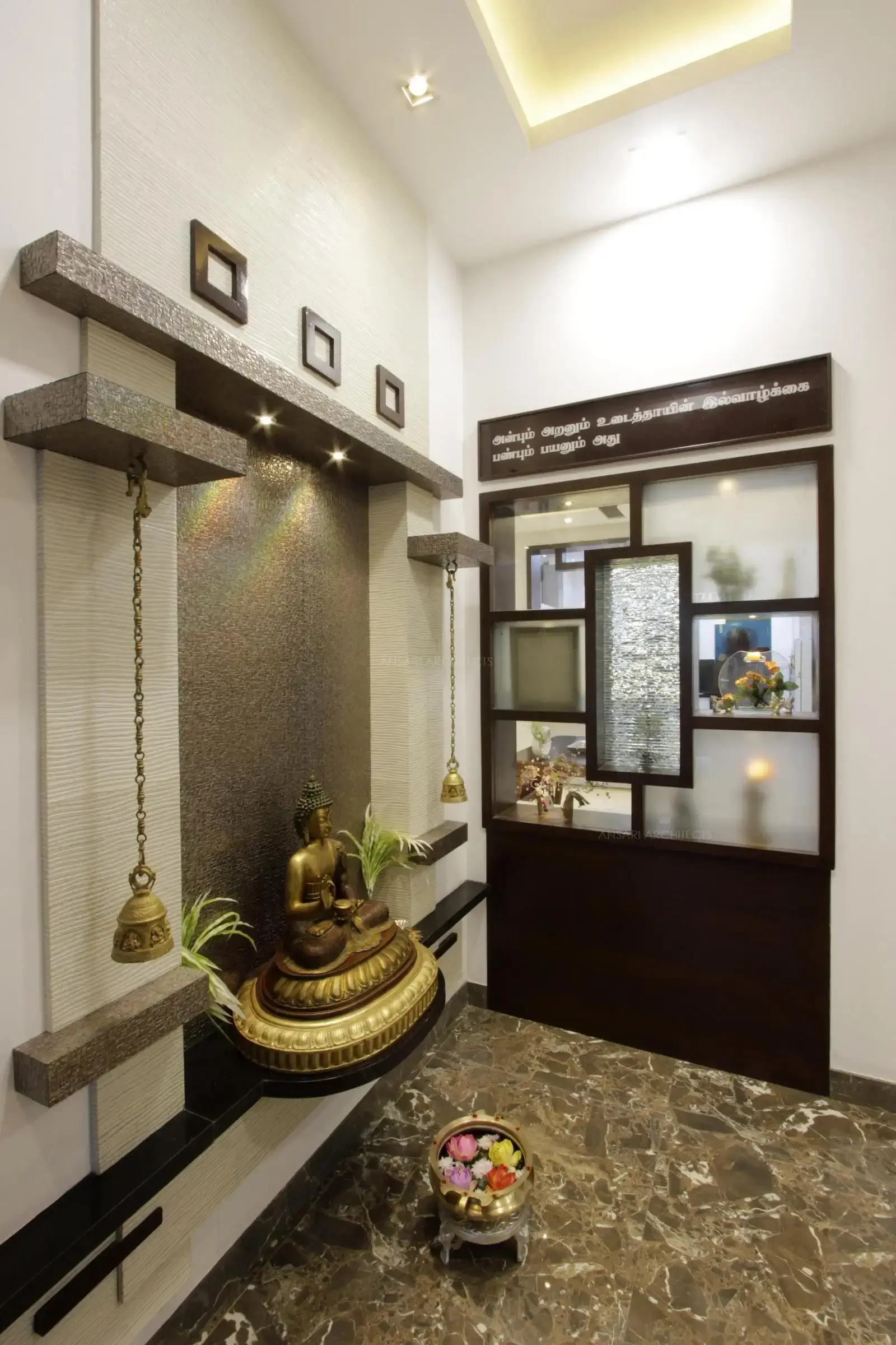 The foyer provides a tranquil vibe, with the Buddha idol with the accent feature in the wall with rock-cut texture elements, the opposite decor wall with glass creates a beautiful eye-catching installation.