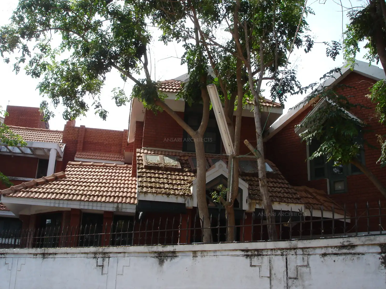 Exterior view of the house done with exposed red bricks.