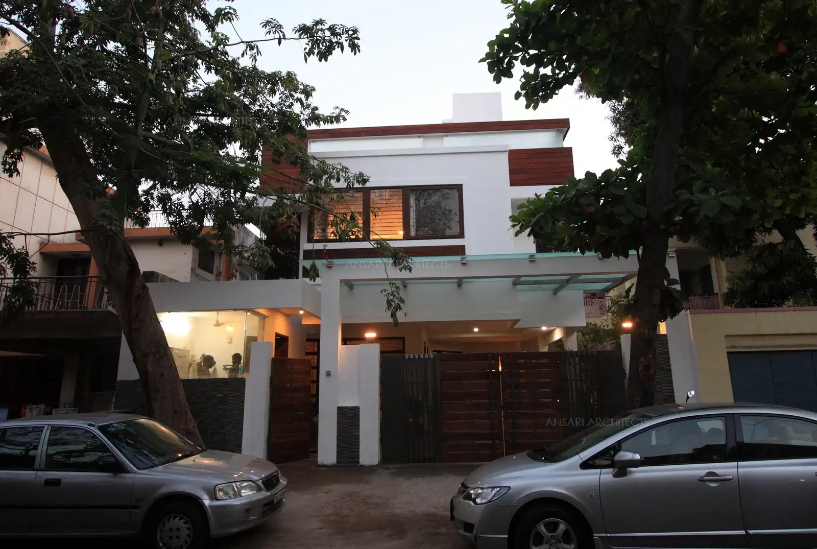 Exterior view of residence has been designed in contemporary style in white finish with combination of wood.