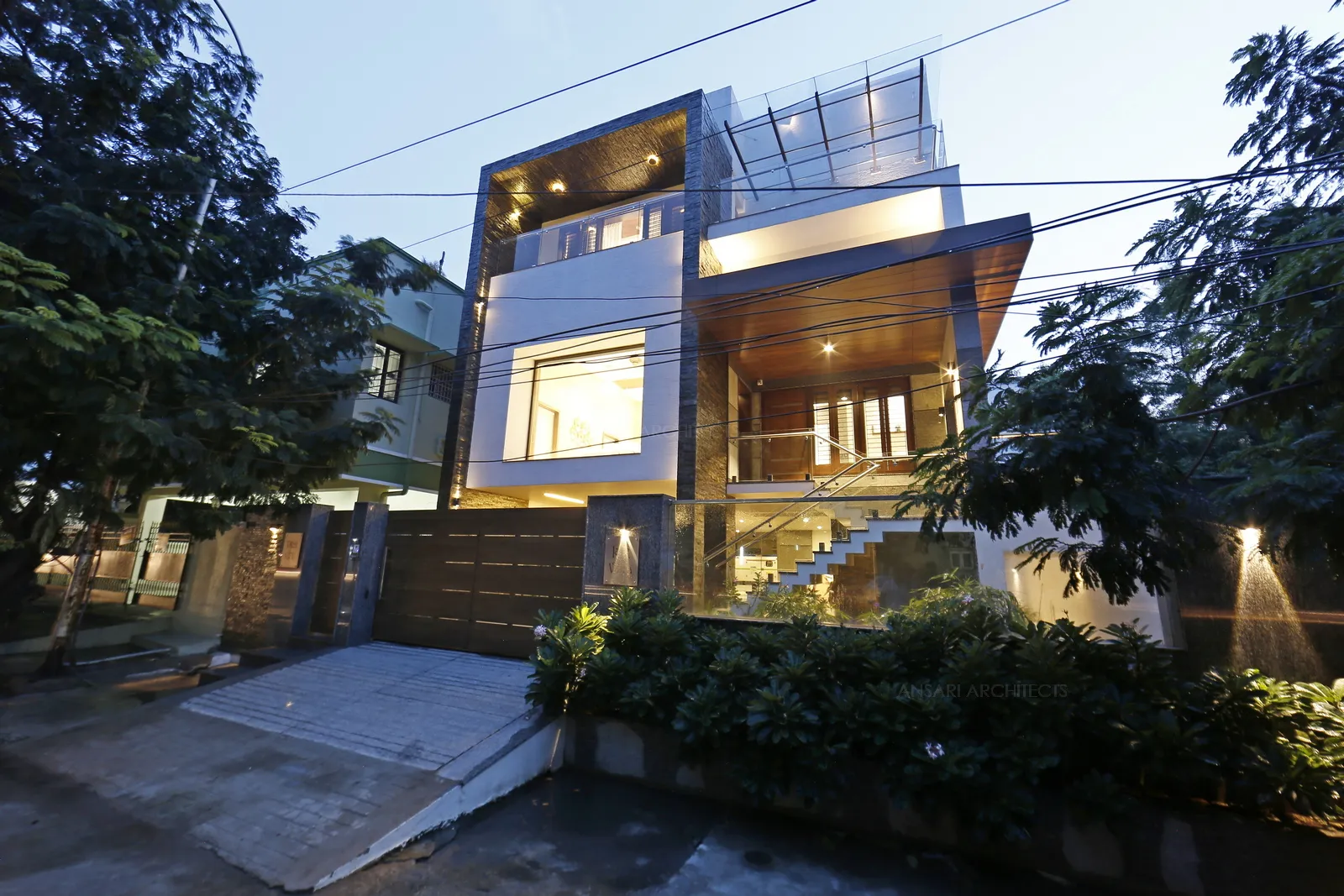 The exterior lighting lends more depth and definition to the structure. Layered spotlights laid across the multi level surfaces adds on to the contemporary scheme of design.
