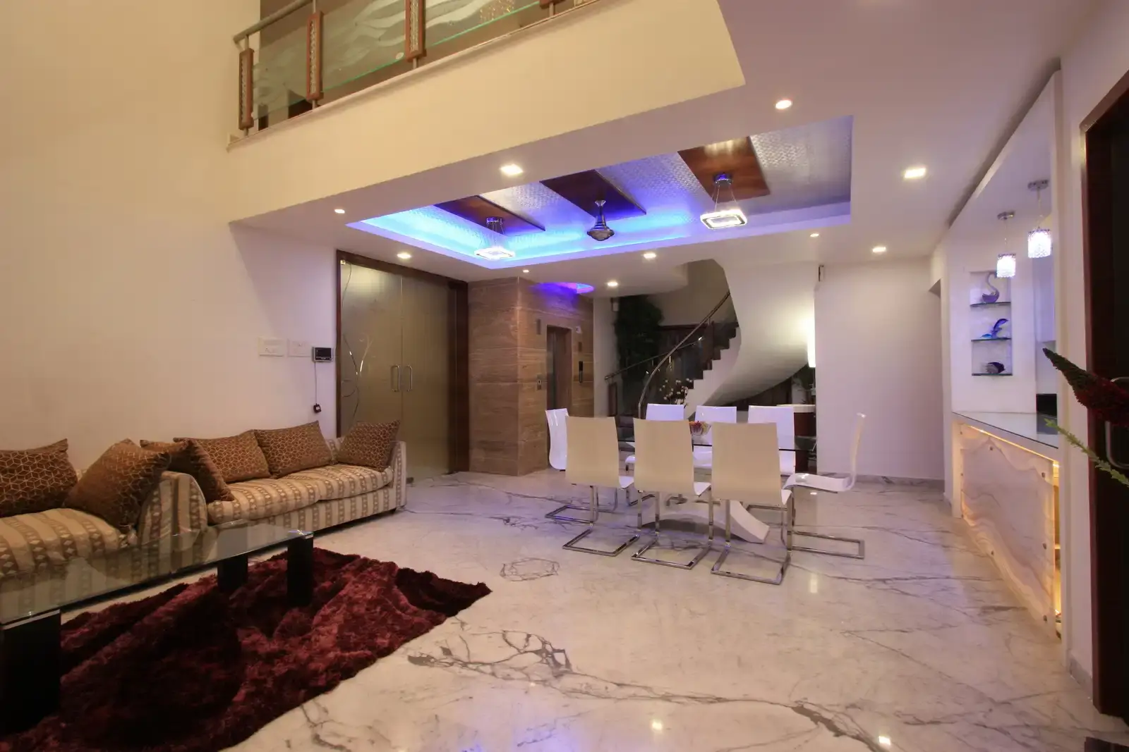 View of dining area showing the marble cladded lift wall and staircase area.