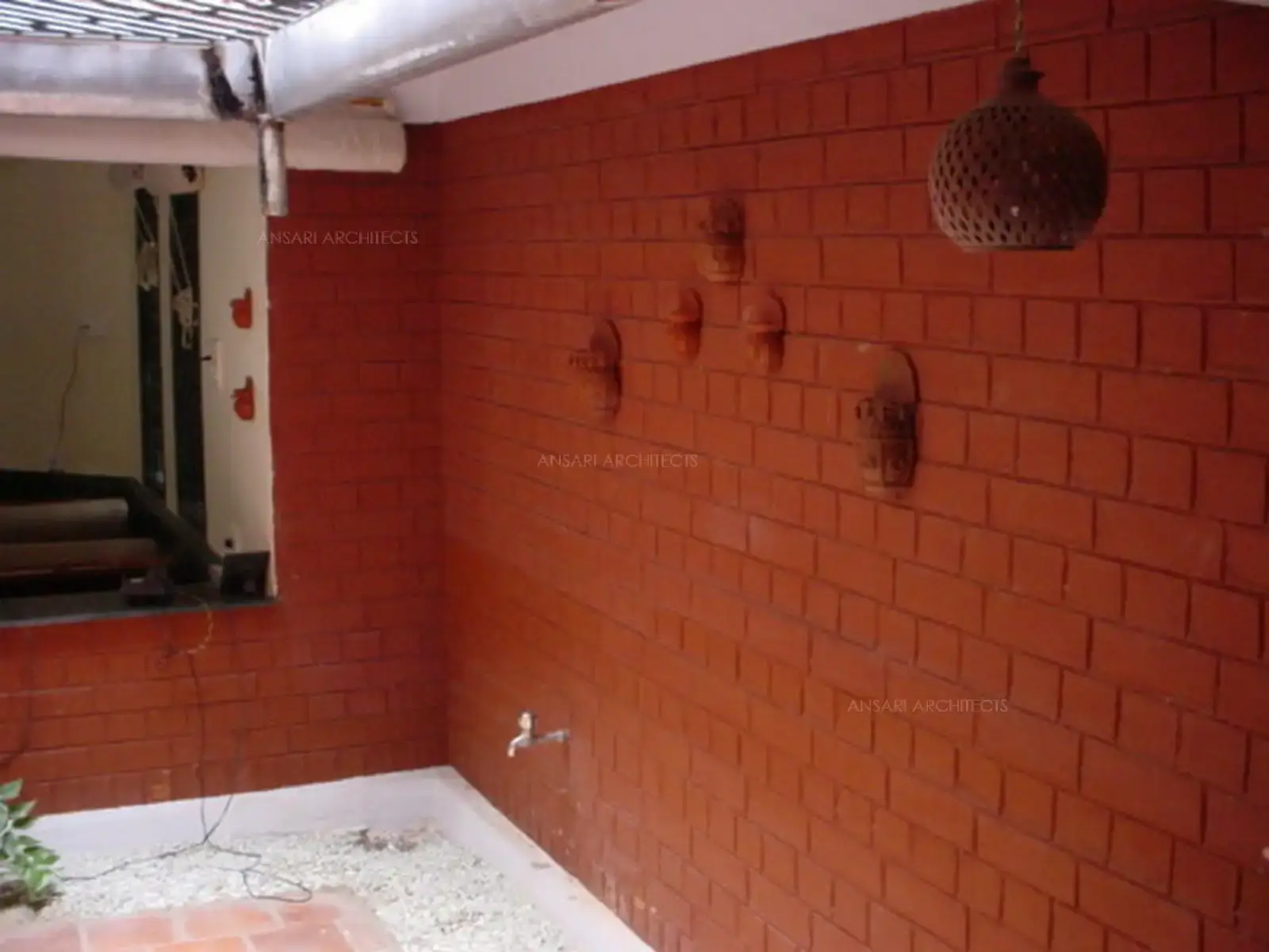 Courtyard finished in natural and rustic red terracotta tiles bricks.