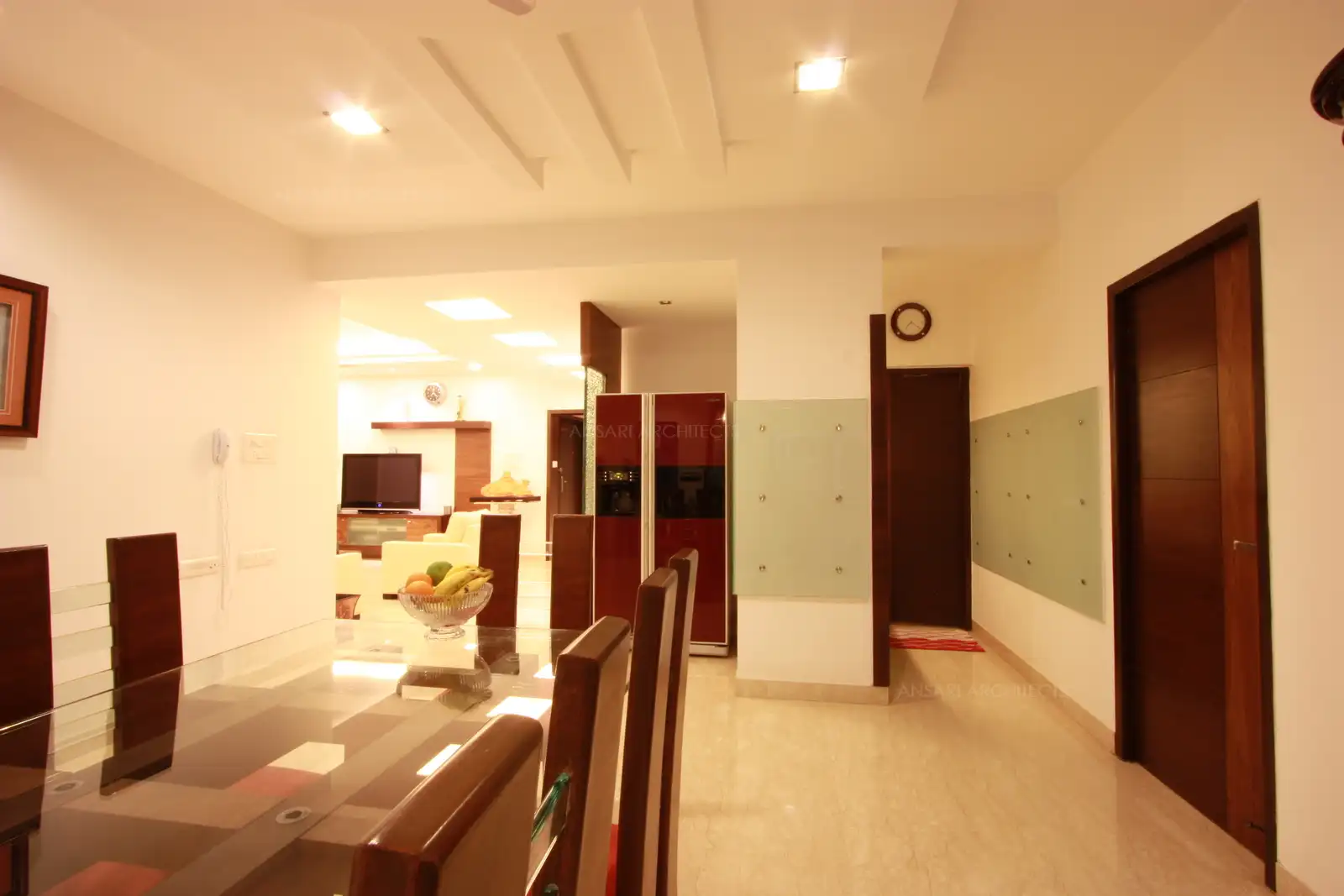 False ceiling in the dining room continues in similar design as living room for a uniform look.