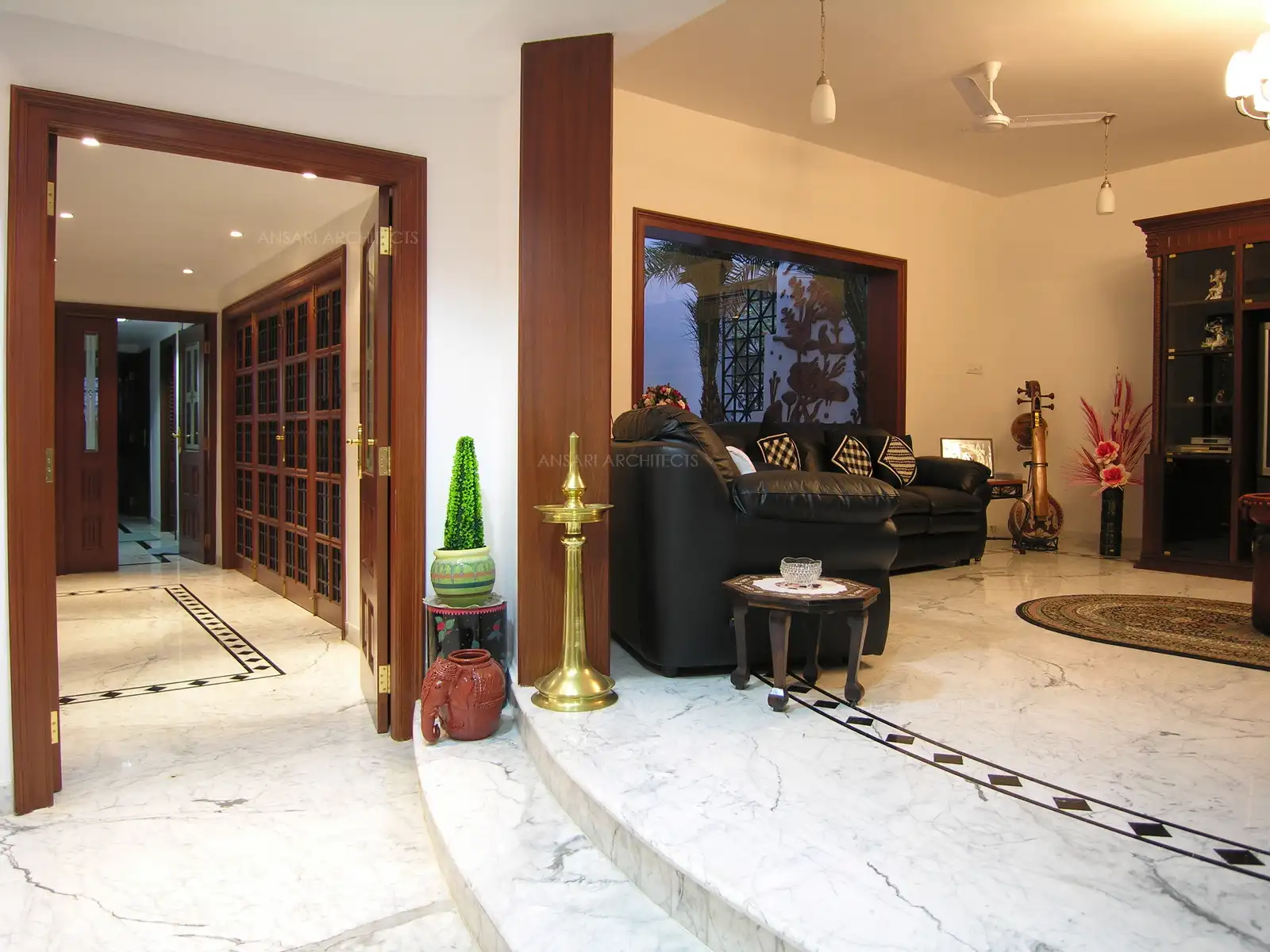 The two steps lead to the living room, demarcating the entrance, and gives an elevated view of the surroundings.