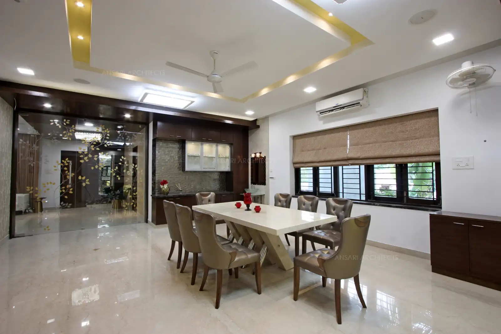 A large glass door with simple floral patterns in the living area leads to the dining area