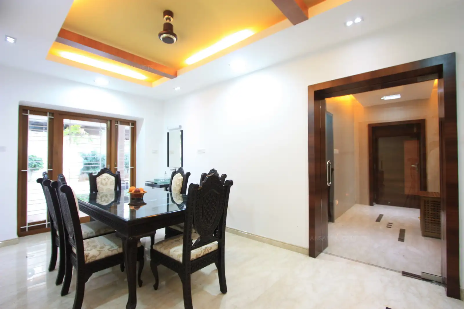 The other side view of the dining room overlooks the garden on the side. While the corridor seen on the right leads to the kitchen and utility areas.
