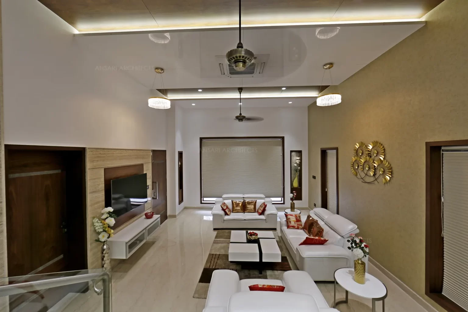 The living area ascends through the dining. The living area explores simple and sleek fixtures and streamlined tv unit.