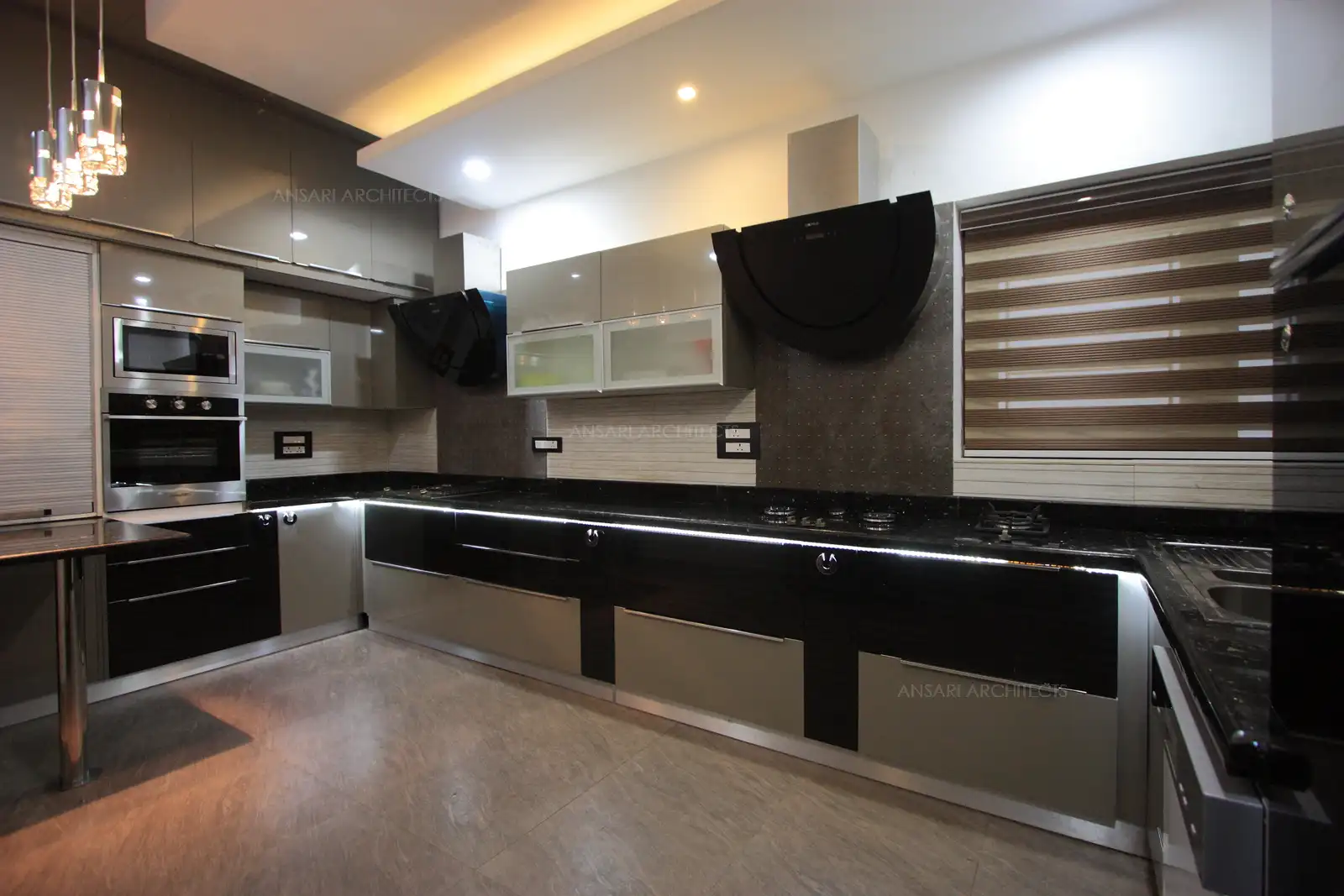 Work space has been smartly divided in this sleek and spacious kitchen.
