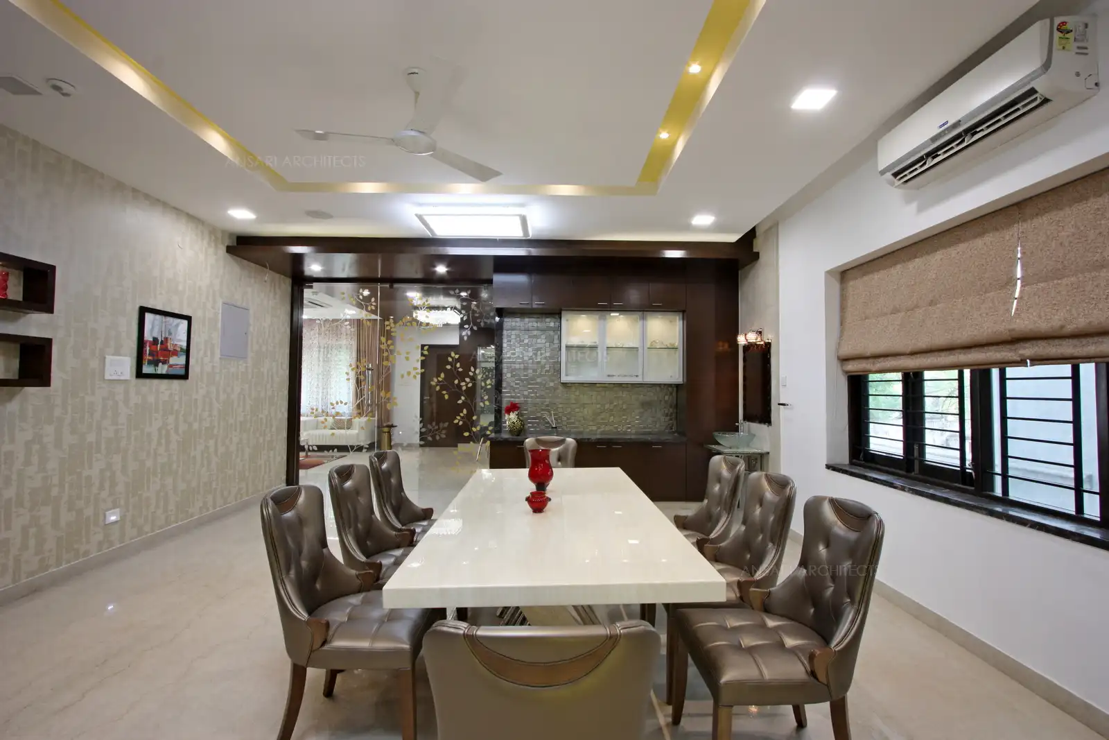 A large glass door with simple floral patterns in the living area leads to the dining area.