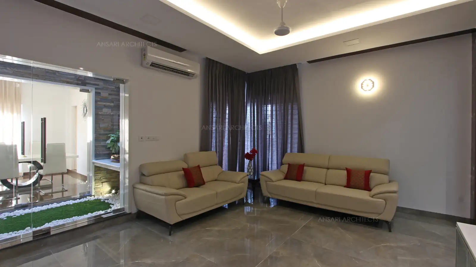 The lighting looks more selective for the specific space like cove lights and the wall sconces here, the colour of the wall visually blends to give a seamless effect. Curtains make the space look complete adding on with the colour.