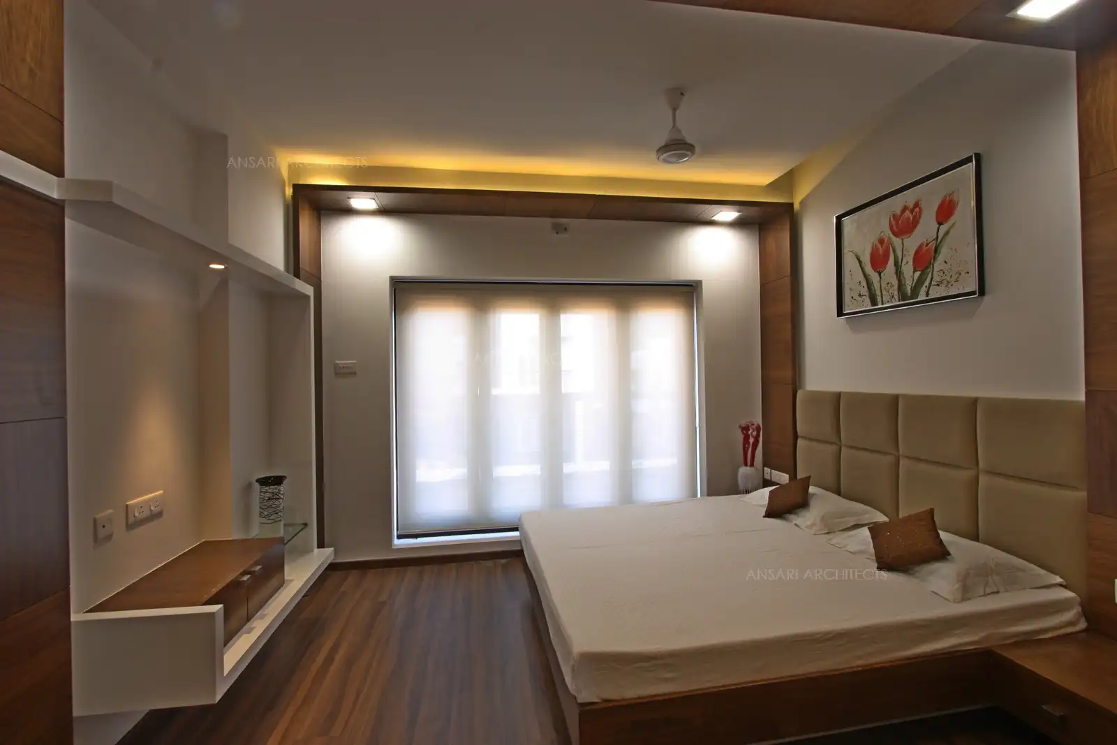A large sliding door with sheer curtains filters in natural light while preserving privacy.
Minimalist furniture and decor maintain a calm, airy atmosphere with functional elegance.