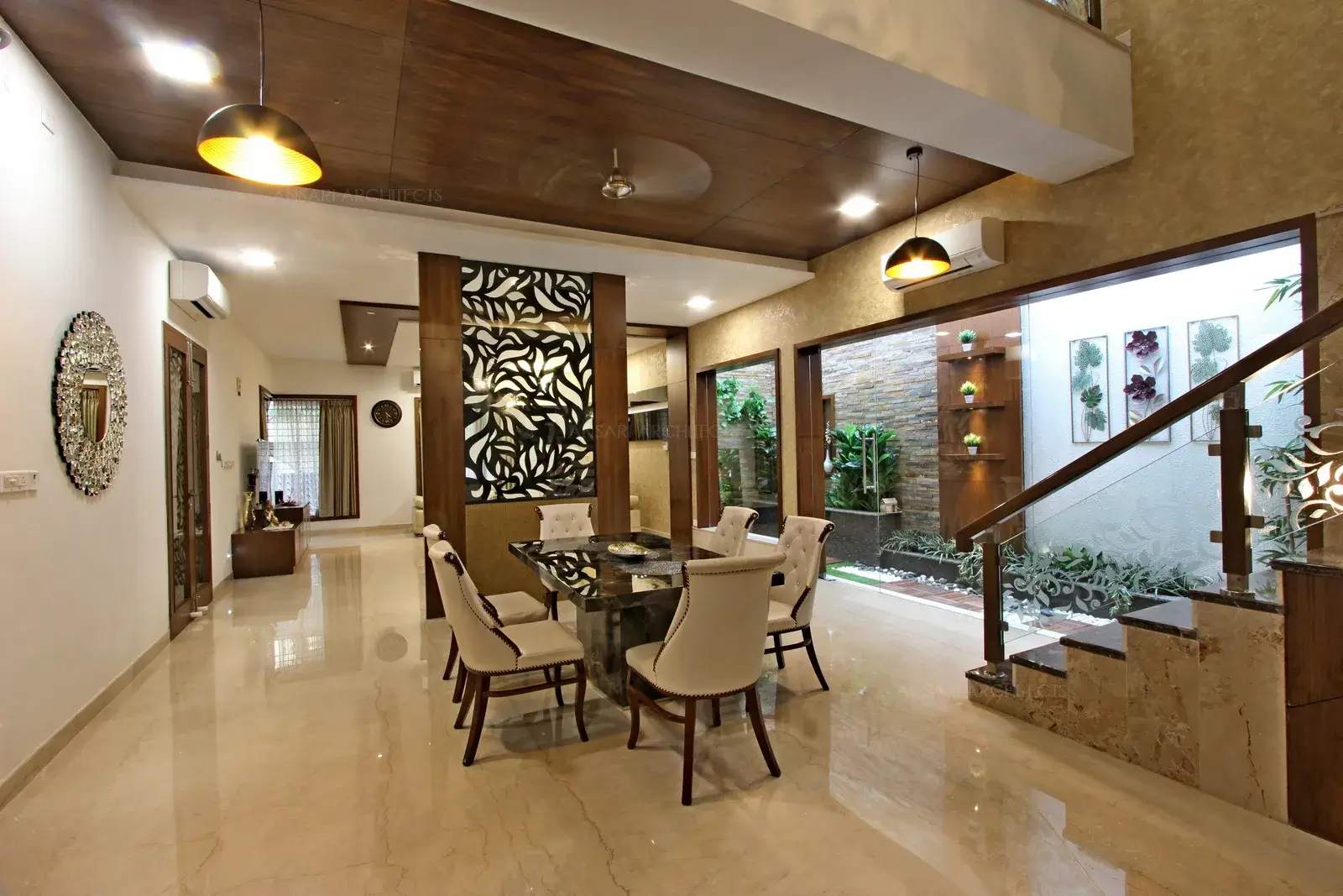 The partition stands as a visual barrier and divides space creating a dining that is segregated from the rest of the space. The flooring infuses a casual vibe to the room.