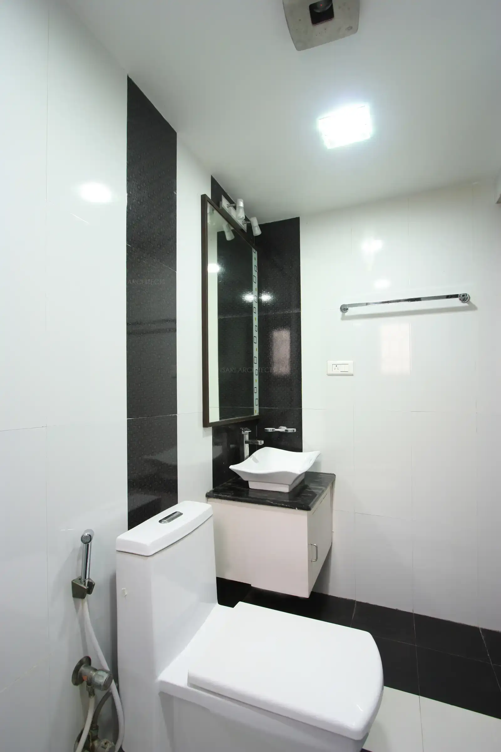 Toilet of bedroom-1 looks sleek and stylish in simple black and white colour scheme
