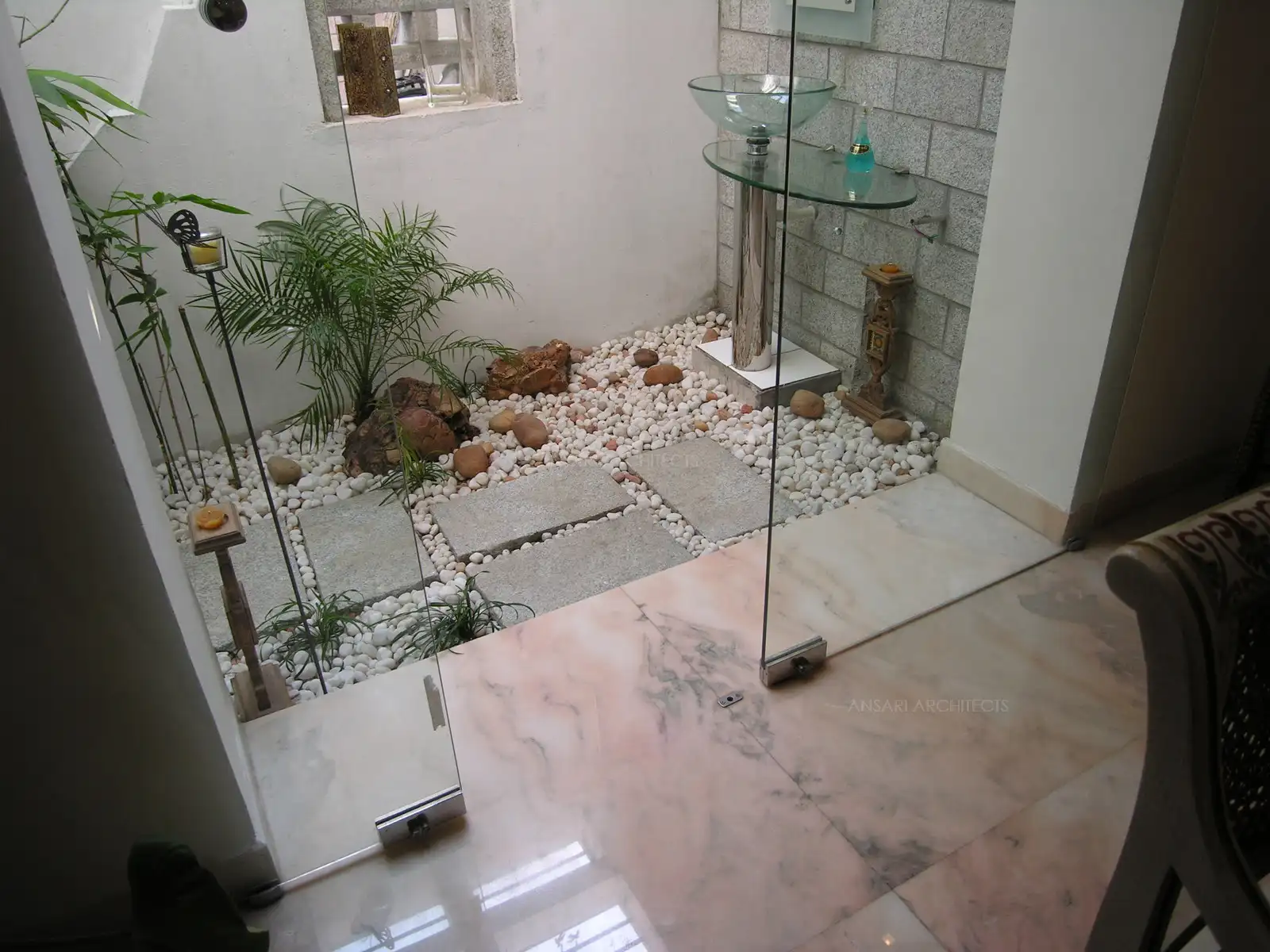 Clear glass sliding door from dining area leads to the courtyard.
