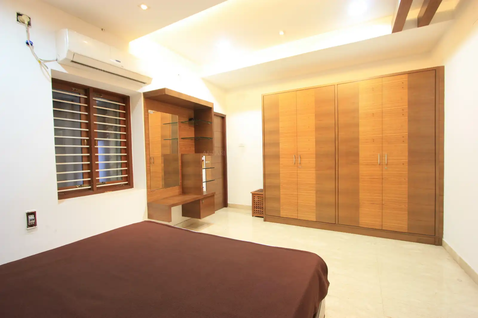 The guest bedroom in the ground floor is fully remodelled with proper wooden wardrobes and wooden dressing tables echoing the heritage