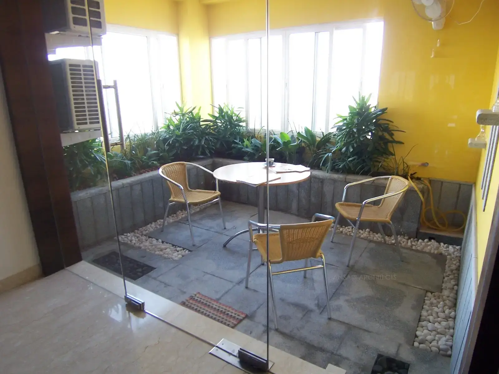 Balcony in the dining area was transformed into a sit out area with stone finished flooring and dry landscape and planter boxes.