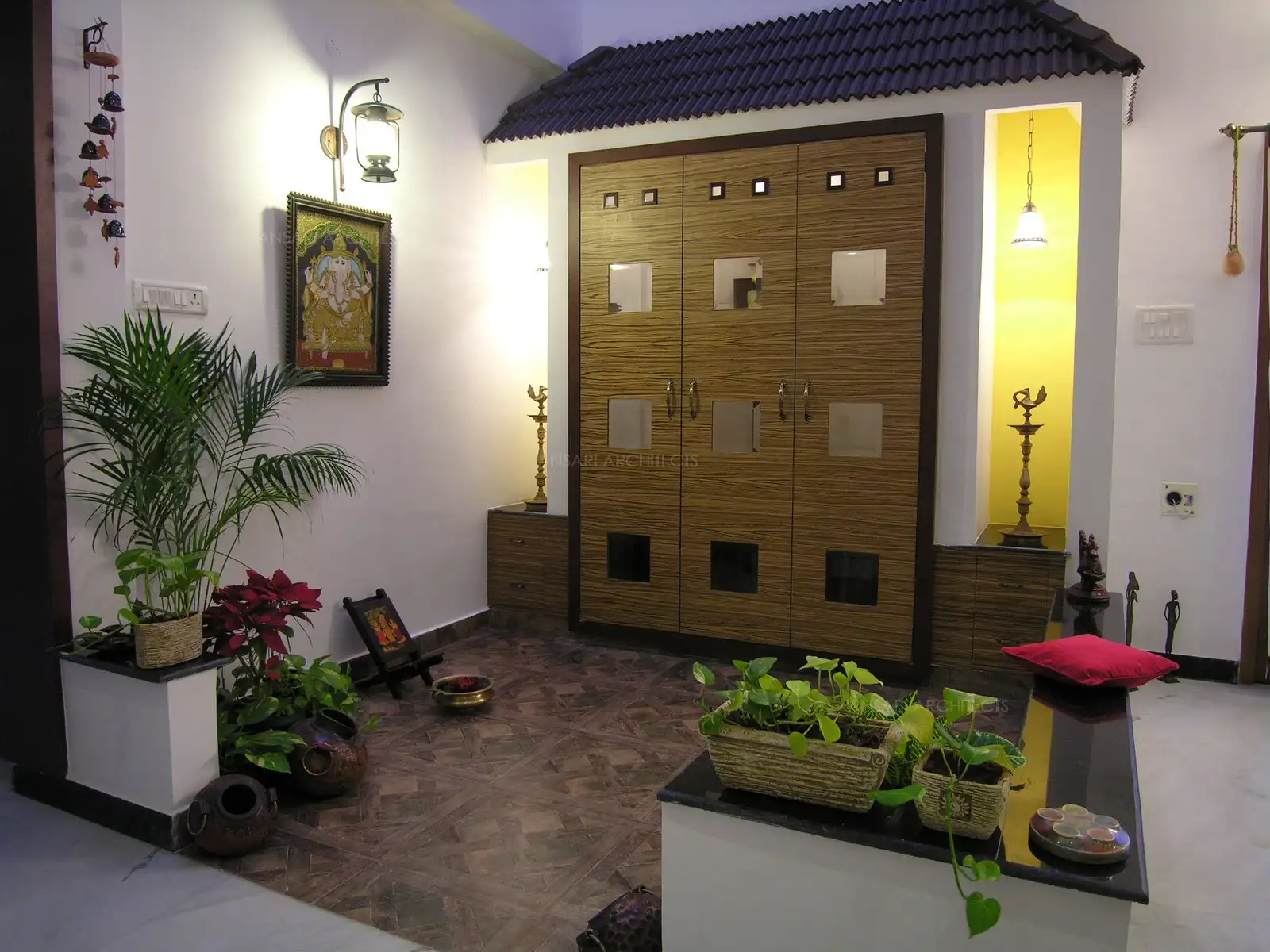 The puja unit doors are simple and contemporary with veneer and glass finish.