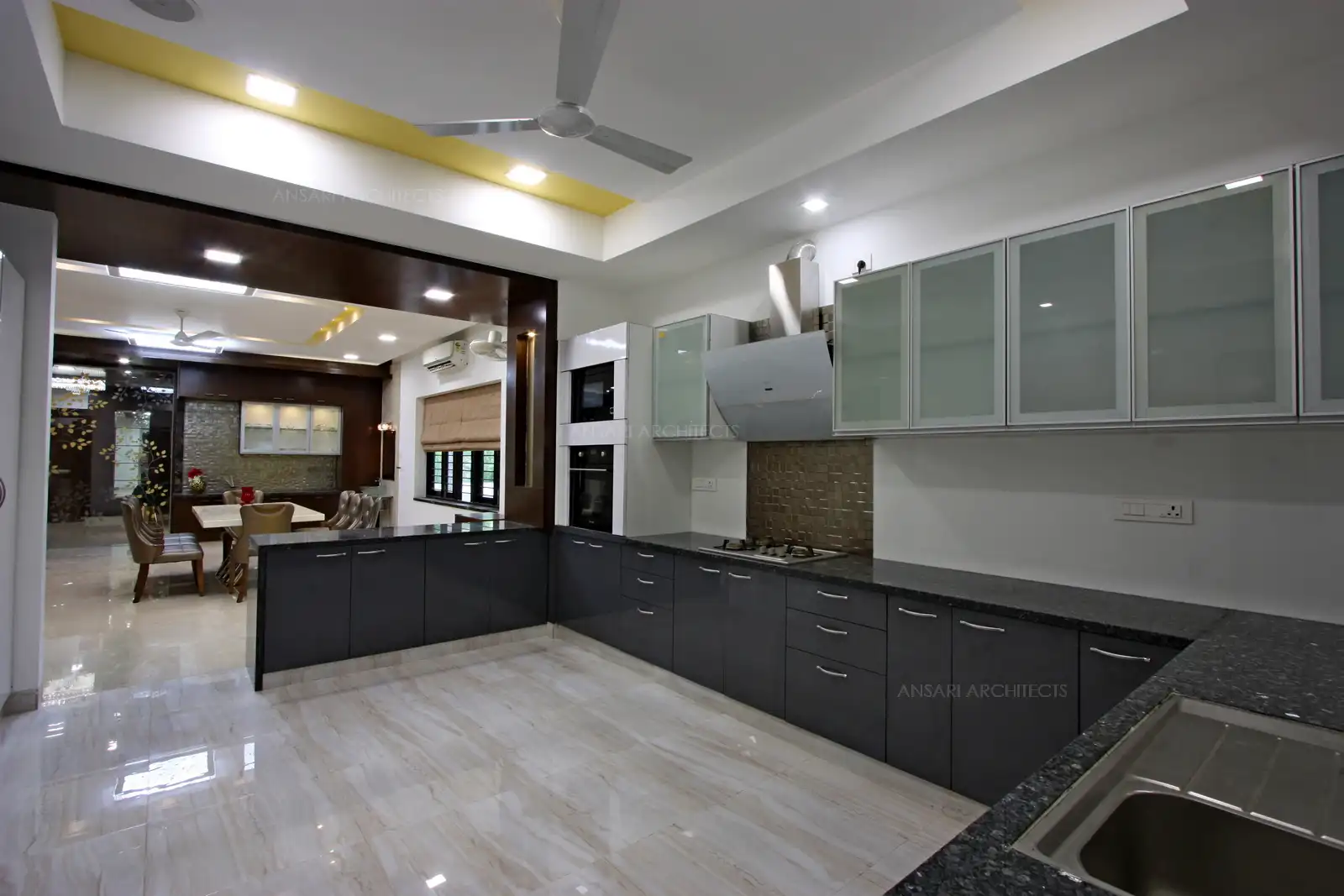 The modular kitchen has been furnished with simple glass cabinets.
