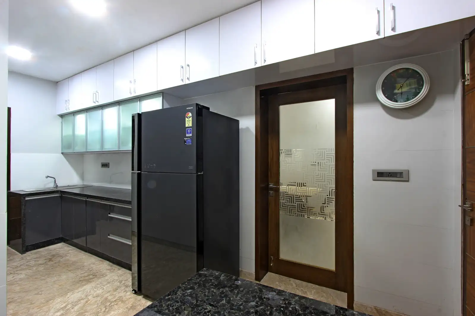 Kitchen is well integrated with a convenient layout , lighting , fixtures and appliances . It's simple yet efficient planning of cooking area.