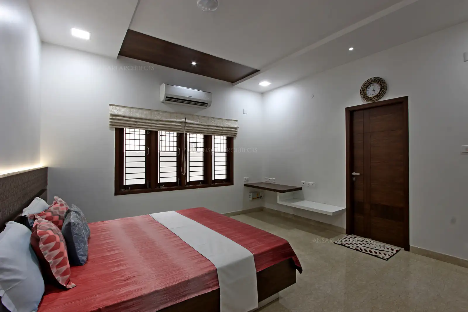 The camouflaged false ceiling at the either side with recessed lights, Veneer panels are versatile and hence the ceiling looks bold. Solid veneer doors add masculine lines and colours for the room. Furnishings are functional and infuses a comfortable space