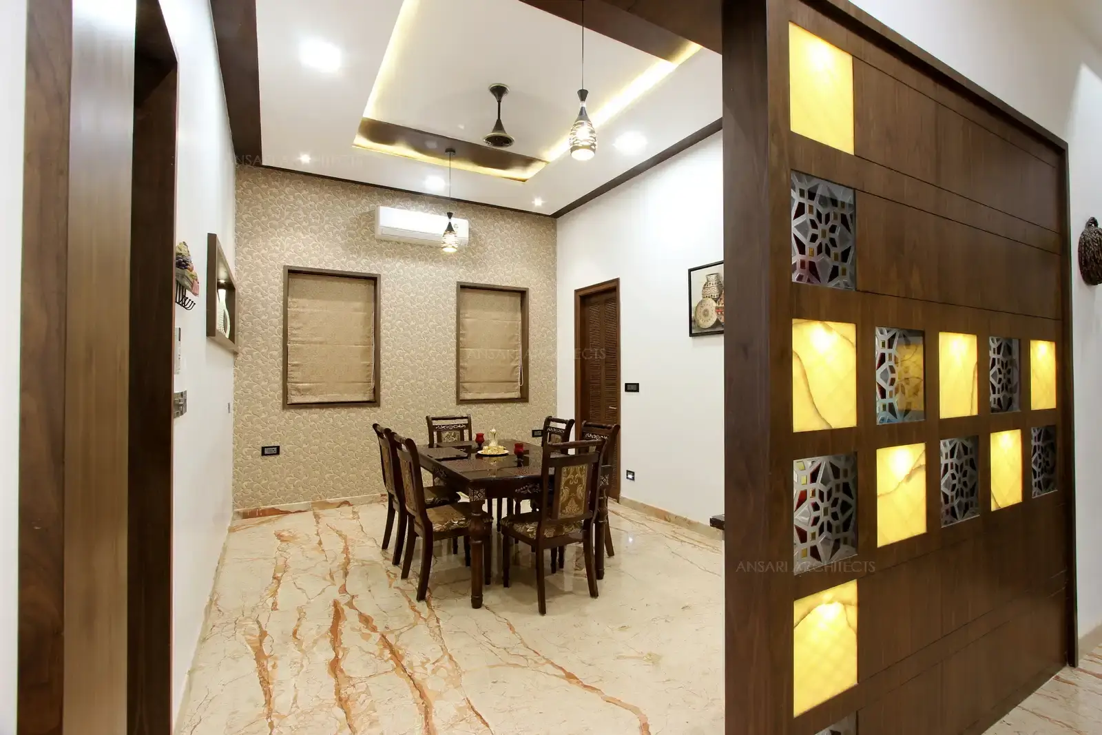 The decorative partition wall of veneer abstraction with vibrant colour pattern leading to the dining area.