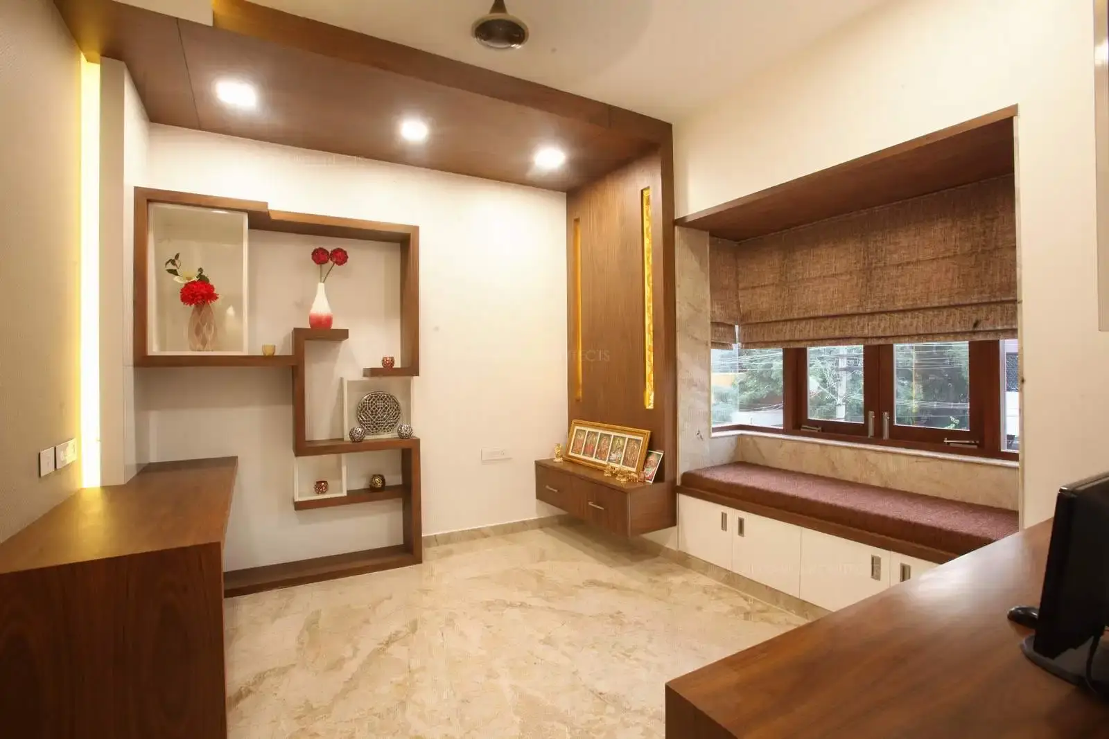 The decorative wooden cladding runs along the entire length of the wall upto the ceiling which visually connects both with better provision for lighting in rectangualr strips. The design of lower cabinets continue onto the walls.