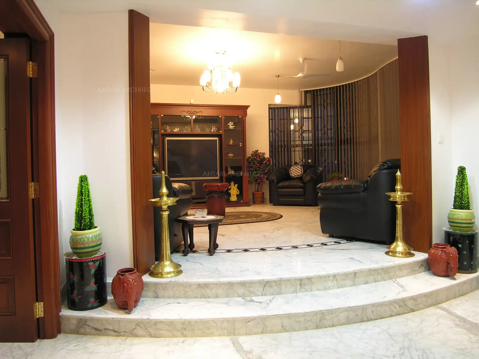 The elevated living room flanked by the traditional brass “Kuthu Vilakku” on either side.